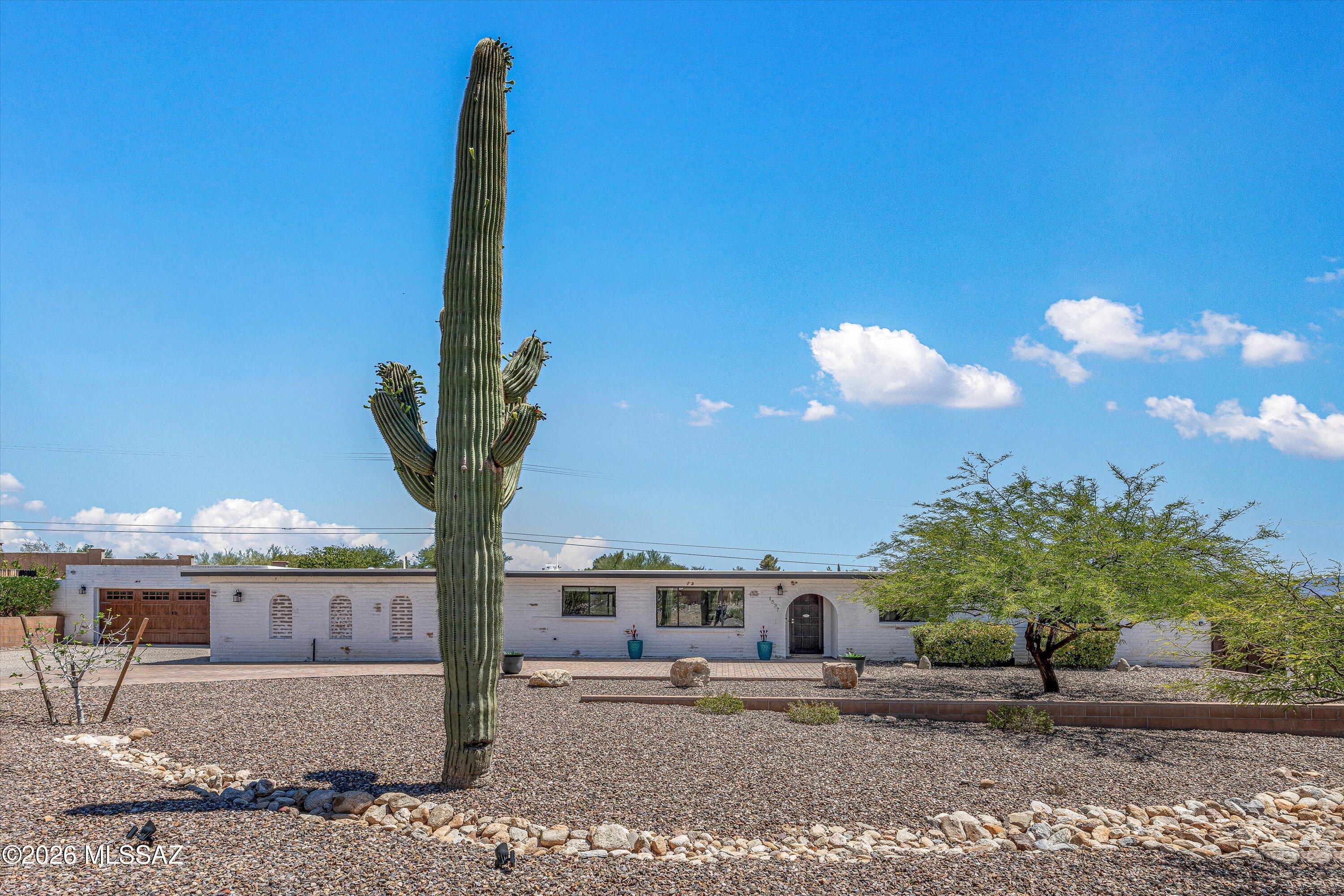 Embrace the perfect combination of classic Arizona character and expansive space in this beautifully positioned and fully renovated Northwest Tucson retreat. This 4BD/3BA with Casita+ Bonus Room+ Self Cleaning and solar heated Pool single-story residence with 4 car garage spaces, is built with durable, energy-efficient slump block construction, a signature Southwest aesthetic celebrated for keeping interiors naturally comfortable year-round. Step inside to discover a remarkably open and light-filled contemporary floorplan. Large common areas offer excellent daily versatility, including a bright living room positioned just off the totally renovated kitchen that serves as a wonderful central hub for cooking, gathering, and casual daily life. The generous layout boasts up to four spacious bedrooms and three full bathrooms, including a private primary retreat. A standout feature is the dedicated extra room that provides the ultimate workspace for a professional studio, hobby workshop, or specialized storage area to suit your lifestyle. The interior flows seamlessly through beautiful ceramic tile and living areas out to an incredible outdoor haven. Positioned on a rare, oversized 0.55-acre lot, the backyard is entirely wrapped in a secure block fence, giving you total peace of mind and an unmatched sense of privacy. Relax on the deep covered rear patio to enjoy Tucson's comfortable year-round weather and soak in the sweeping mountain silhouettes that frame the horizon. Location is everything, and this property places you right in the middle of convenience. Complete with a central location, you are just minutes away from upscale shopping, Trader Joe's, dining at the Casas Adobes Plaza, and the lush desert trails of Tohono Chul Park. It is a spectacular choice for buyers seeking space, durability, and a premier Arizona lifestyle!