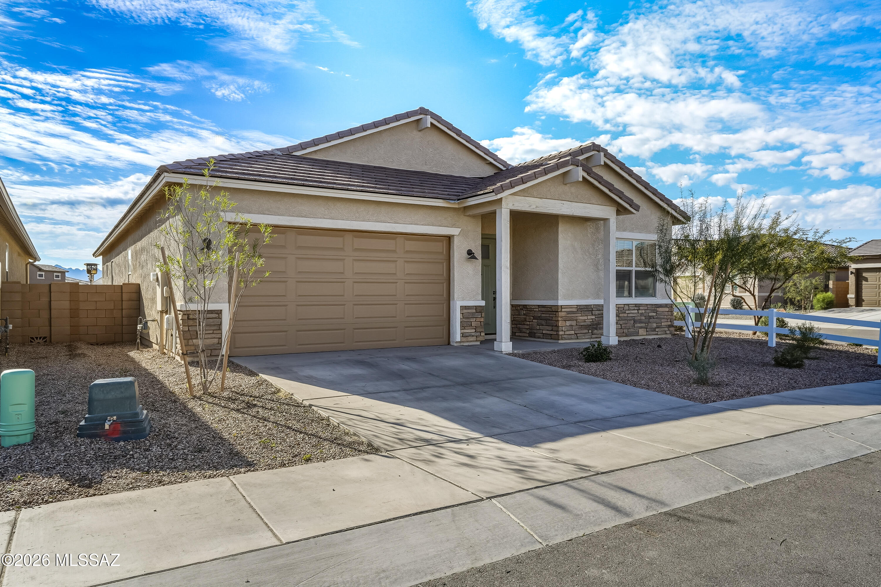 Stunning, move-in-ready 2024 built home blends modern luxury with custom upgrades rarely found at this price point. Offering 4 bedrooms and 3 bathrooms, the thoughtful split floor plan provides both comfort & privacy. The chef's kitchen features granite countertops, upgraded appliances,large center island, abundant cabinetry, & spacious walk-in pantry, all flowing seamlessly into the expansive great room with soaring ceilings & multiple dining areas. Large glass doors open to a beautifully designed backyard with custom pavers & artif turf -ideal for entertaining. Premium corner lot backing to a greenbelt, this home offers exceptional privacy. Located in the desirable Gladden Farms, less than a mile from Marana comm. center, close to freeway access, shopping, entertainment! Better than NEW