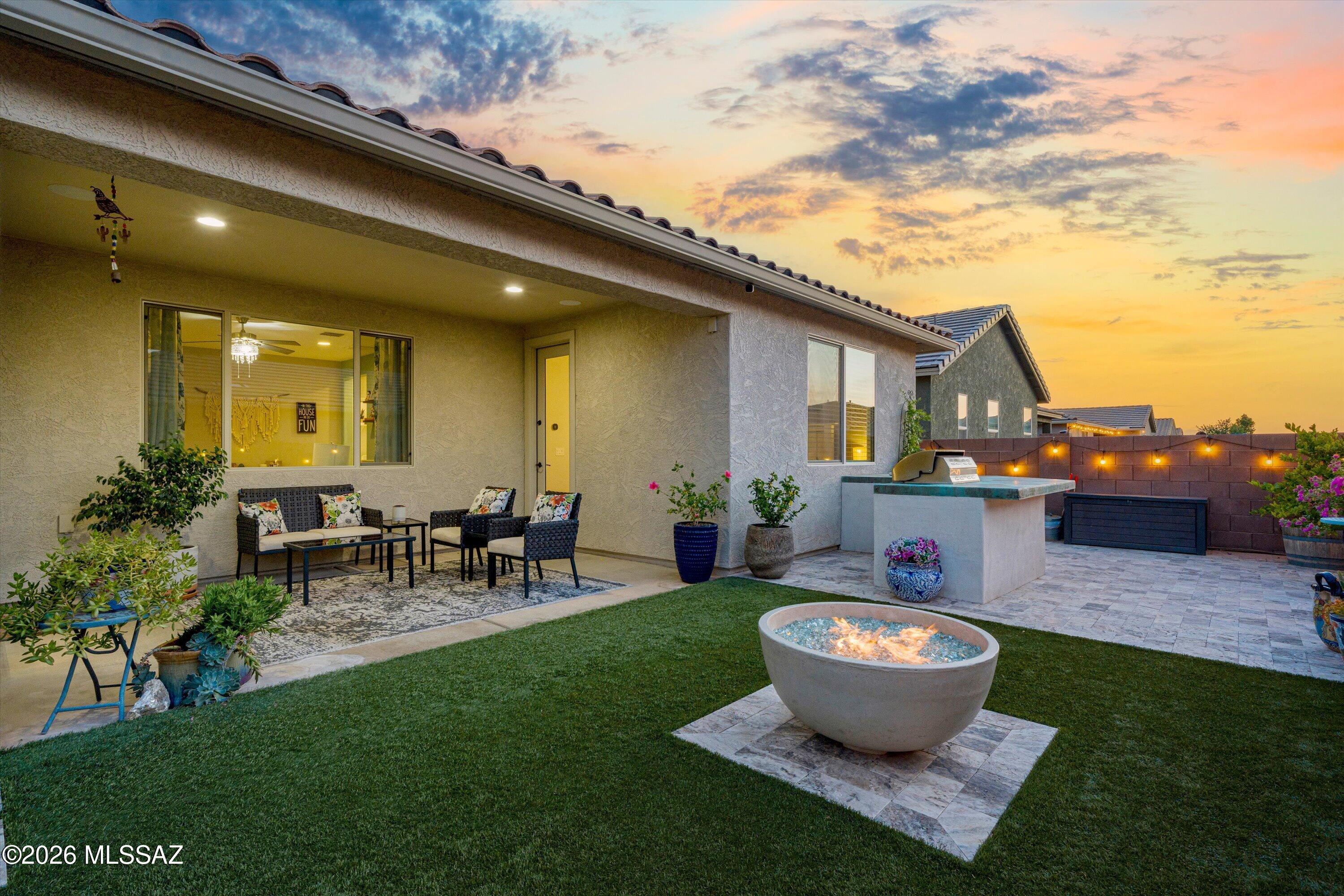 Situated on a corner lot, this distinctive Ocotillo floor plan was only available on corner homesites & offers 3 bedrooms, 2.5 baths, a den, & 2,141 sq ft of thoughtfully designed living space. The chef's kitchen features upgraded cabinetry, a generous island, premium granite countertops, & plenty of space for cooking, gathering, & entertaining. Designer touches continue throughout the home with upgraded lighting, interior shutters, tile flooring in the main living areas, & a custom-made barn door leading to the versatile den. The spacious primary suite features an upgraded bath with premium granite countertops, upgraded cabinetry & fixtures, & a spacious walk-in shower finished with an upgraded frameless glass door. Additional highlights include ceiling fans in the bedrooms, upgraded insulation throughout, an Ecobee WiFi-enabled smart thermostat with sensors in three areas, and adjustable drop-down garage shelving.

Step outside to a backyard designed for entertaining and enjoying Arizona evenings. Travertine pavers and artificial turf create an inviting, low-maintenance setting, while the built-in BBQ and gas fire bowl are great focal points for any gathering. Café lighting, patio speakers, and a custom water wall feature add to the atmosphere, whether you're hosting a crowd or simply relaxing at the end of the day. Front and back landscaping is conveniently maintained with drip irrigation and an adjustable timer.

And then there's the neighborhood--one of the best parts of calling this home. Enjoy a true sense of community with a pool, parks, splash pads, basketball courts, soccer fields, and community events throughout the year. A beautifully upgraded home with spaces designed for both everyday living and entertaining.