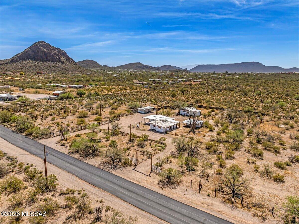 Views, solitude, & privacy.  Have it all on this beautiful 2.85+ acre horse property. Incredible value & opportunity. Flat, very buildable & easily accessible. Close to town but feels like a different world. Quiet, no outlet street. Corner lot. NO HOA! A true compound awaiting a new owner to transform it into their dream ranch. Main house is 1,174 sqft. Guest house is 690 sqft. Perfect for multigenerational needs with room to grow. Two workshops with electricity. Fenced area for livestock and pets. The photography is nice but to truly appreciate this property it must be viewed in person. A gem of the southwest desert. Property sits adjacent to 40 acres of federally owned land that is pristine, natural desert. Imagine the possibilities. Won't last. Schedule your a showing today. Owner/Agent