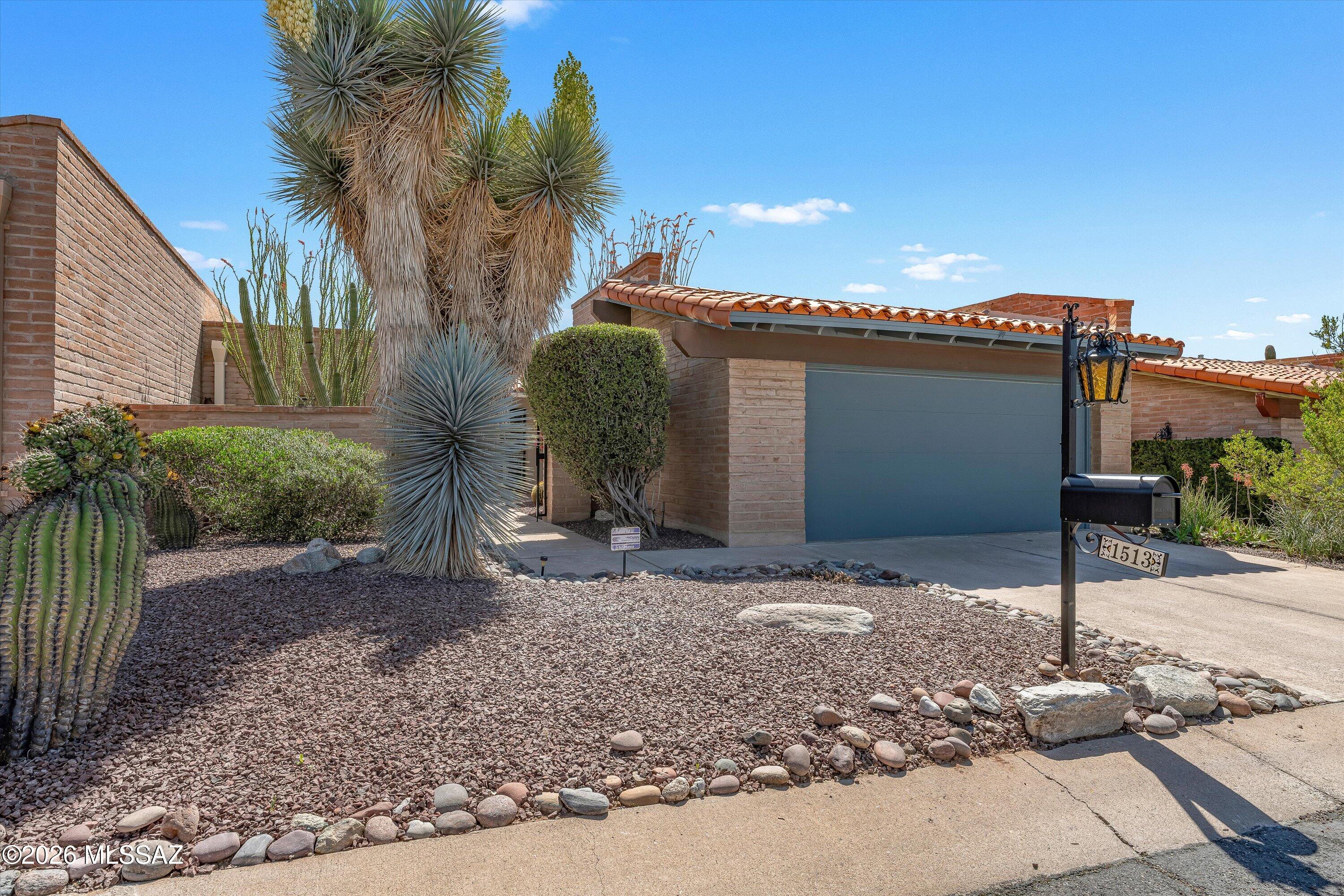 Largest Wilford Built Townhome boasts energy-efficient burnt adobe to keep you cool during the summer! This 3BD/2BA (1,891 sq ft) home features wrought iron gates & doors plus plantation shutters throughout, offering ultimate privacy and security. Charming, gated courtyard flows to a spacious living/dining room with gorgeous plank flooring, dual sliders off rear patio, plus woodburning fireplace with tile surround. Expansive kitchen with large breakfast nook offers plenty of room to prepare meals with ample countertops & cabinetry. Spacious Owner's suite with rear patio access hosts ensuite bath with dual-sink vanity plus walk-in shower and closet. Bedroom 2 adjoins hall bath. Third bedroom (or office) with double door entry accesses front courtyard. Additional features include granite countertops and illuminating skylights in kitchen & baths, solar tube in laundry room plus 2-car garage with storage closet. Retreat to the covered rear patio with full wrought iron enclosure, outer pavers and peeks of the mountains. This property is meticulously landscaped with mature desert plantings and flowering shrubs. Enjoy the Community pool, spa, recreation center and park-like setting with sports court.