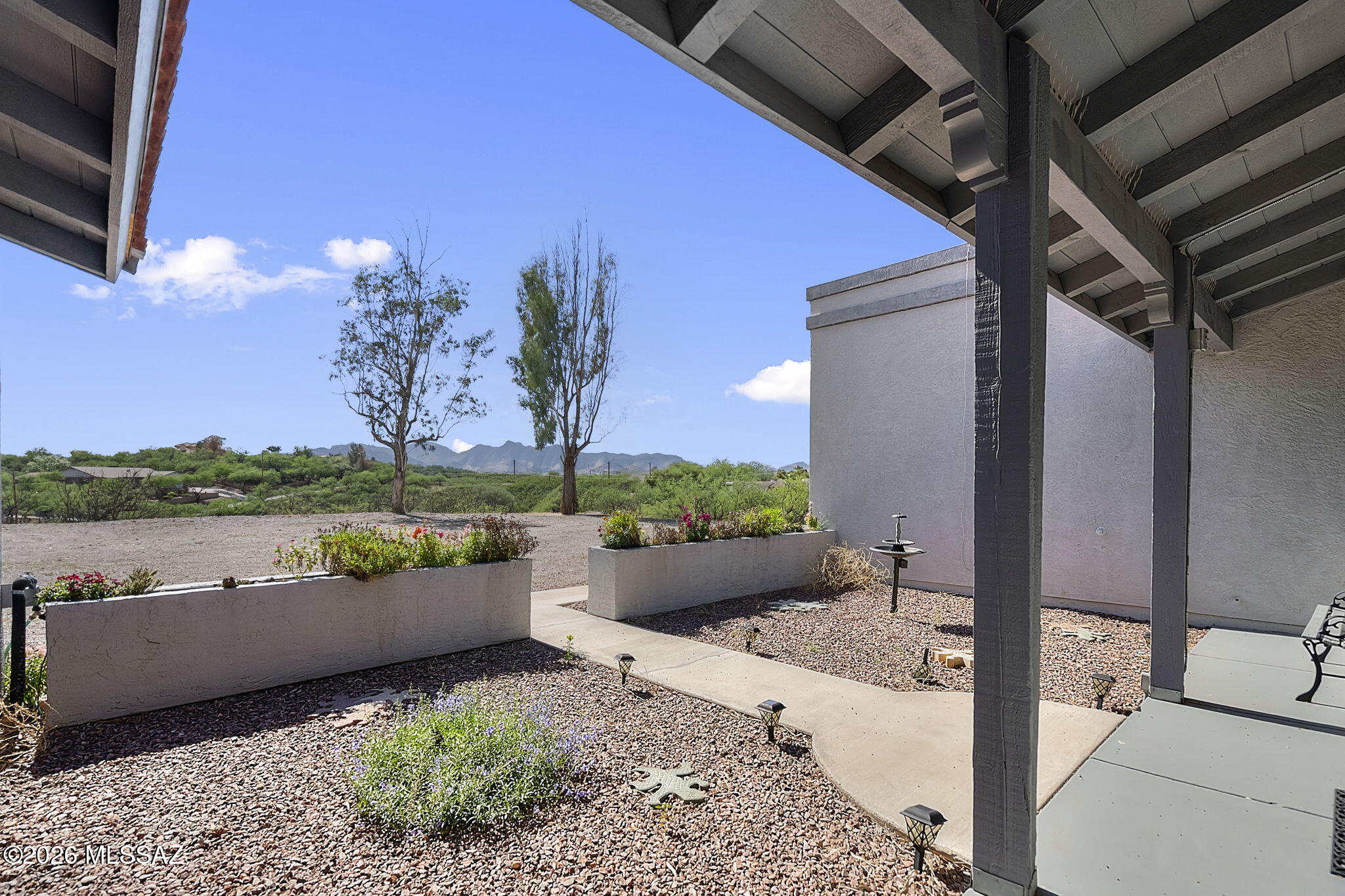 Welcome to this beautifully built, solidly constructed home where quality and charm stand the test of time. Featuring durable 6-inch walls, this residence offers impressive energy efficiency and craftsmanship you can feel the moment you step inside.
Perched in an elevated position in Rio Rico, this property captures breathtaking panoramic views in every direction--enjoy the stunning San Cayetano and Santa Rita Mountains from your backyard, and the Atascosa Mountains from the front. Despite its peaceful, private setting, you're just minutes--approximately four minutes--from grocery stores, schools, and easy freeway access.
Inside, the home offers 3 spacious bedrooms and 2 bathrooms, providing comfortable living with plenty of room for everyone. Large windows throughout fill the home with abundant natural light, creating a warm and inviting atmosphere.
The oversized garage is a standout feature, boasting two deep bays perfect for trucks, along with two generous storage or workshop rooms--ideal for hobbies, tools, or additional workspace.
Situated on over an acre, this property offers incredible potential to expand and customize. Whether you envision adding a detached shop, RV or boat parking, a pool, or a covered patio for outdoor entertaining, the possibilities are endless.
If you're looking for a well-built home with space, views, and opportunity, this Rio Rico property is one you won't want to miss.
Seller is open to Seller Carry! Call for more information! 

(***Seller Is Currently taking any backup offers)