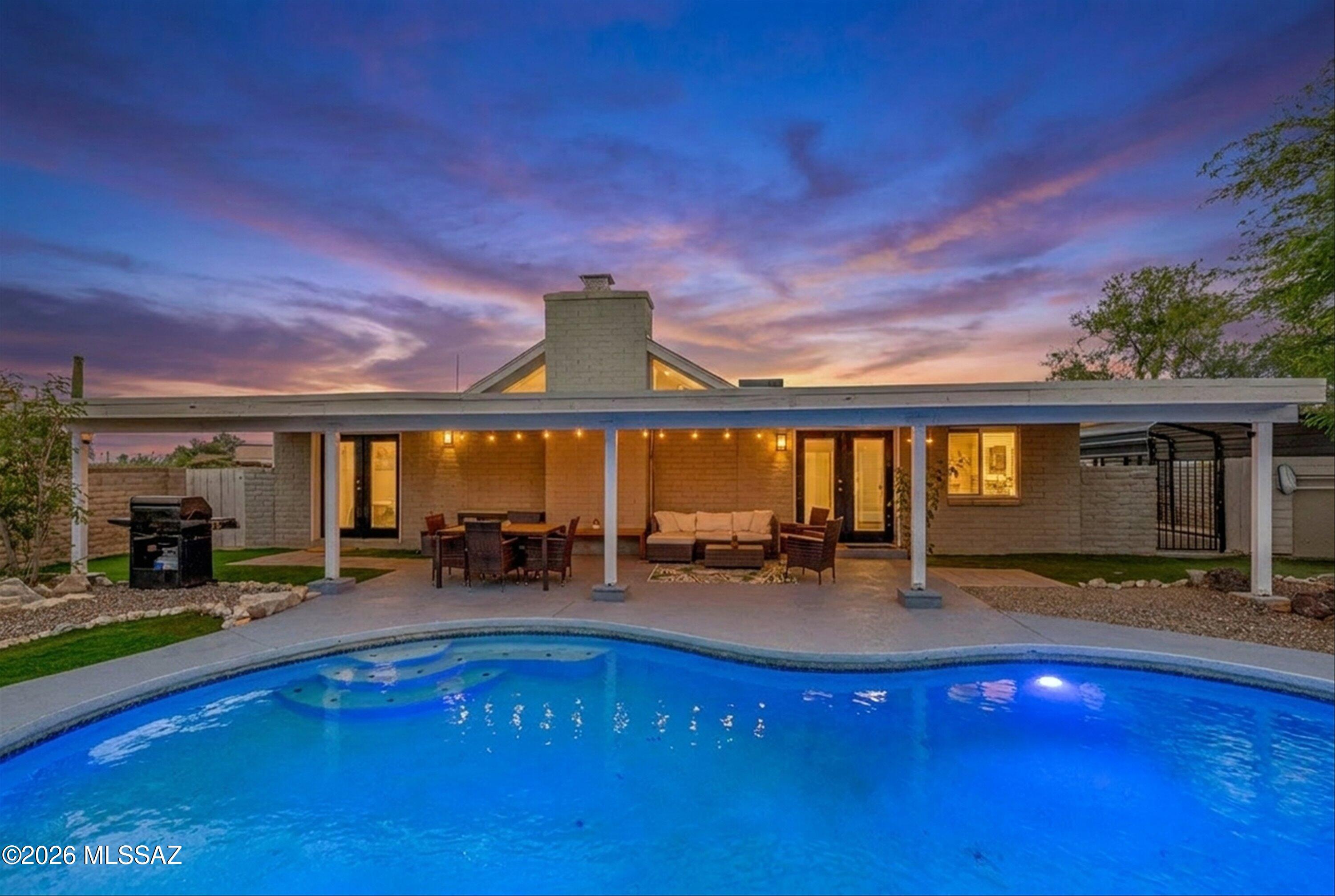 Beautifully updated 5 bed, 2 bath home in sought after Casa Adobes West on a spacious .64 acre lot. This 2,469 sqft home features vaulted beamed ceilings, abundant natural light, a dramatic wood burning fireplace, and an open concept layout perfect for entertaining. The chef's kitchen offers a large island, quartz countertops, and ample storage. The spacious primary suite includes backyard and pool access. Outside enjoy a refreshing pool, covered patio, and expansive artificial turf with room for gatherings, games, and outdoor living. Flexible floor plan with additional bedrooms and office space. Conveniently located near shopping, dining, and everyday amenities.