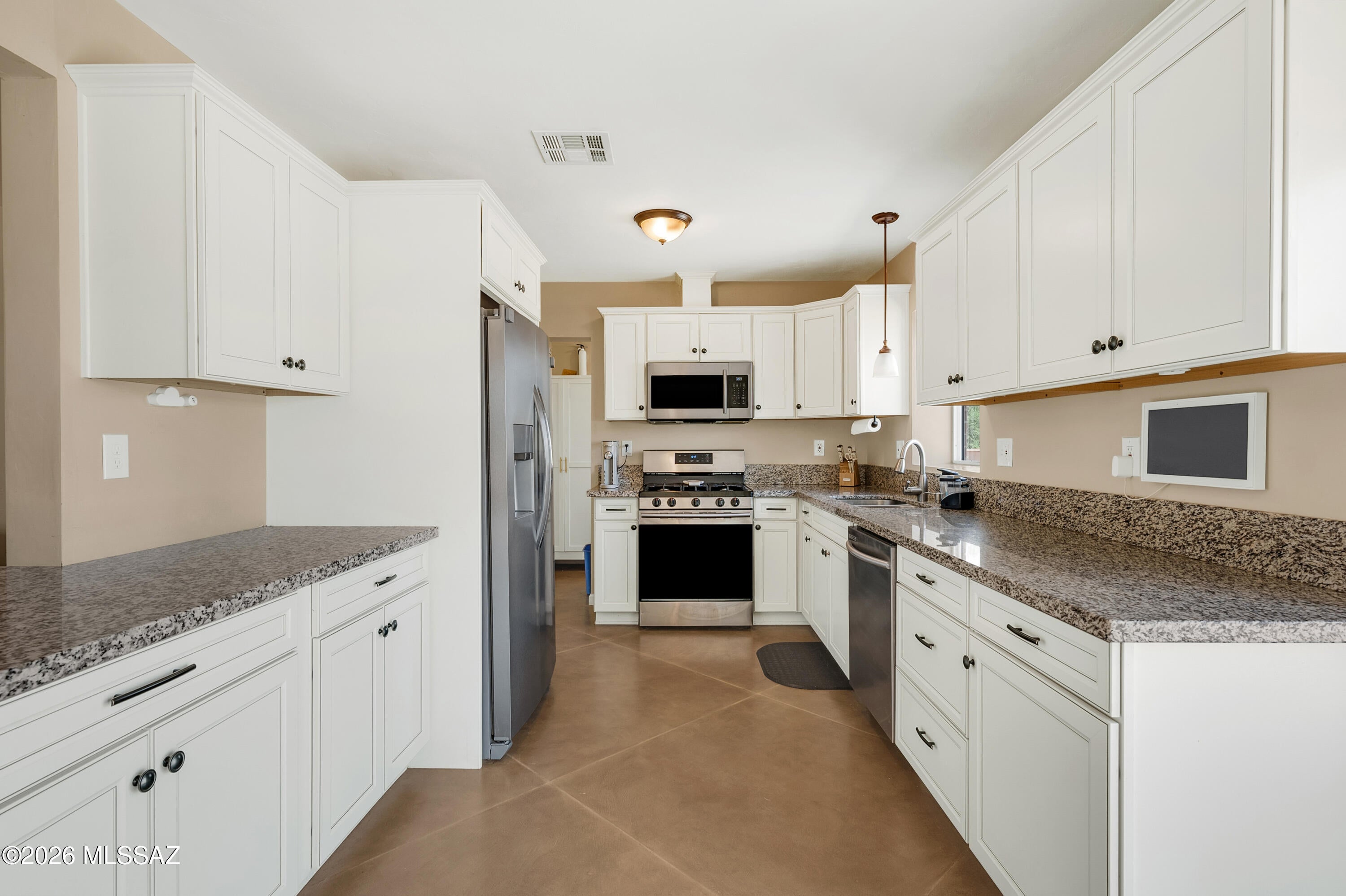NO HOA & ASSUMABLE 4.5% LOAN! Qualified buyers can take over a rate today's market can't touch. Beautifully upgraded red-brick home on large 9,479 sf lot in central-east Tucson. Open living room flows to a bright dining room and a remodeled kitchen with white shaker cabinets, granite slab
counters, stainless appliances and gas range. 4 beds and 2 upgraded bathrooms across 1,522 sf, and easy-care stained concrete floors, plus laundry is inside. A showstopping backyard: pavers, patio under a ramada, artificial turf, desert landscaping, storage shed and block-wall privacy with alley access. Minutes to Broadway shopping, dining, parks and Davis-Monthan. Move-in ready with Newer: Roof A/C Water Heater & Windows. Assumption subject to lender approval. See it now before it's gone!