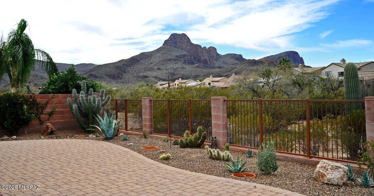 Upgraded Continental Reserve home on premium lot backing to common area and Sombrero Peak View!  Large great room off kitchen with tile everywhere except 2 bedrooms & the den area. Kitchen has huge island with breakfast bar, stainless appliances, solid surface counter tops and tile back splash.  Primary bath has granite countertops with dual undermounts sinks.  Beautiful shutters throughout.  Low care rear yard has view fence to common area, large covered patio and extensive pavers.  Beautiful decorative wrought iron doors at front and rear doors from living room & primary bedroom.  3 car tandem garage.  Split bedroom plan.  All appliances included.  HVAC and water heater new in 2018.  Roof checked and routine maintenance completed in Feb 2026.  Don't miss this amazing home!