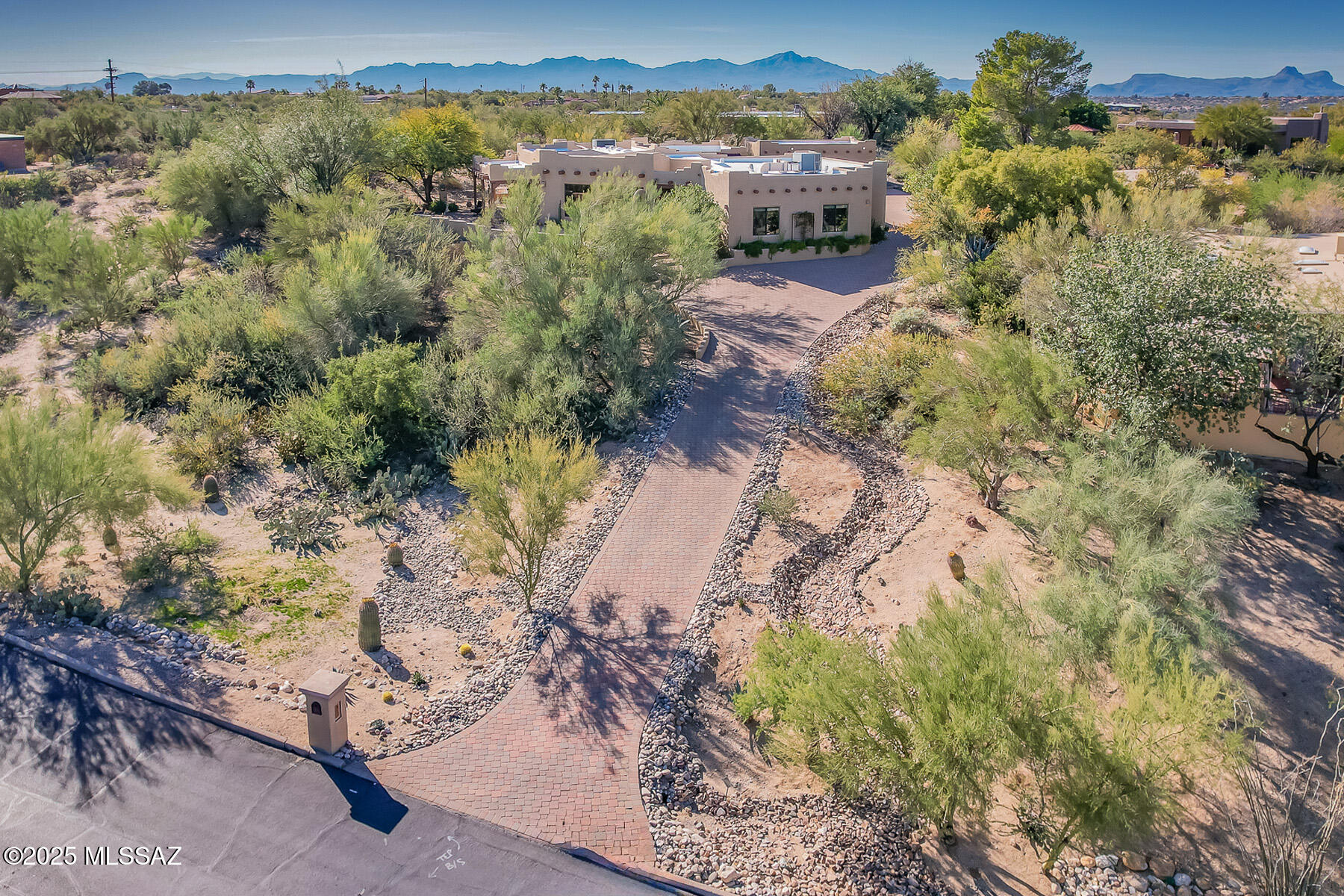 Phenomenal 3BD/3.5BA Santa Fe in Oro Valley Country Club is ideally situated on an elevated .84 acre lot boasting privacy plus panoramic Catalina & Tortolita mountain views. This exquisite 2,917 sq ft main home offers dual Primary Suites plus a resort style yard with solar heated pool, woodburning fireplace and built-in gas BBQ station. Wraparound paver drive flows to front entrance, large side courtyard with hot tub, 3 car garage and detached 689 sq ft multi-use building with two private entry, heated/cooled rooms with stained concrete floors (one has potential for a casita). This impeccable estate boasts a reimagined Gathering room encompassing open concept living & dining areas plus sleek, modern kitchen. Southwest architecture melds with modern convenience featuring soaring viga beam ceilings, oversized diagonal set tile, built-in media wall with gas fireplace & surround, triple view windows w/ rolling sunshades, and a gourmet kitchen with granite counters, gas cooktop and in-wall ovens, plus expansive island with breakfast bar. Extended laundry room/butler's pantry hosts beverage bar, dual storage closets, utility sink and 1/2 bath. Harper's distinctive cabinetry in kitchen, baths & laundry plus Andersen 'Heritage' energy-efficient windows. Primary suite #1 off courtyard hosts updated luxury bath w/ dual sink vanity, dual walk-in closets plus glass block shower. Primary #2 offers en suite bath while bedroom 3 accesses full hall bath (both feature walk-in closets). Newer zoned air conditioning (5 years), recently replastered pool w/ PebbleSheen, plus all new windows in 2012. Enjoy the tranquil outdoor patios with string lights and sunshades, sound speakers, updated landscaping, extensive pavers plus awe-inspiring sunsets upon the Catalinas. A true oasis in the desert!