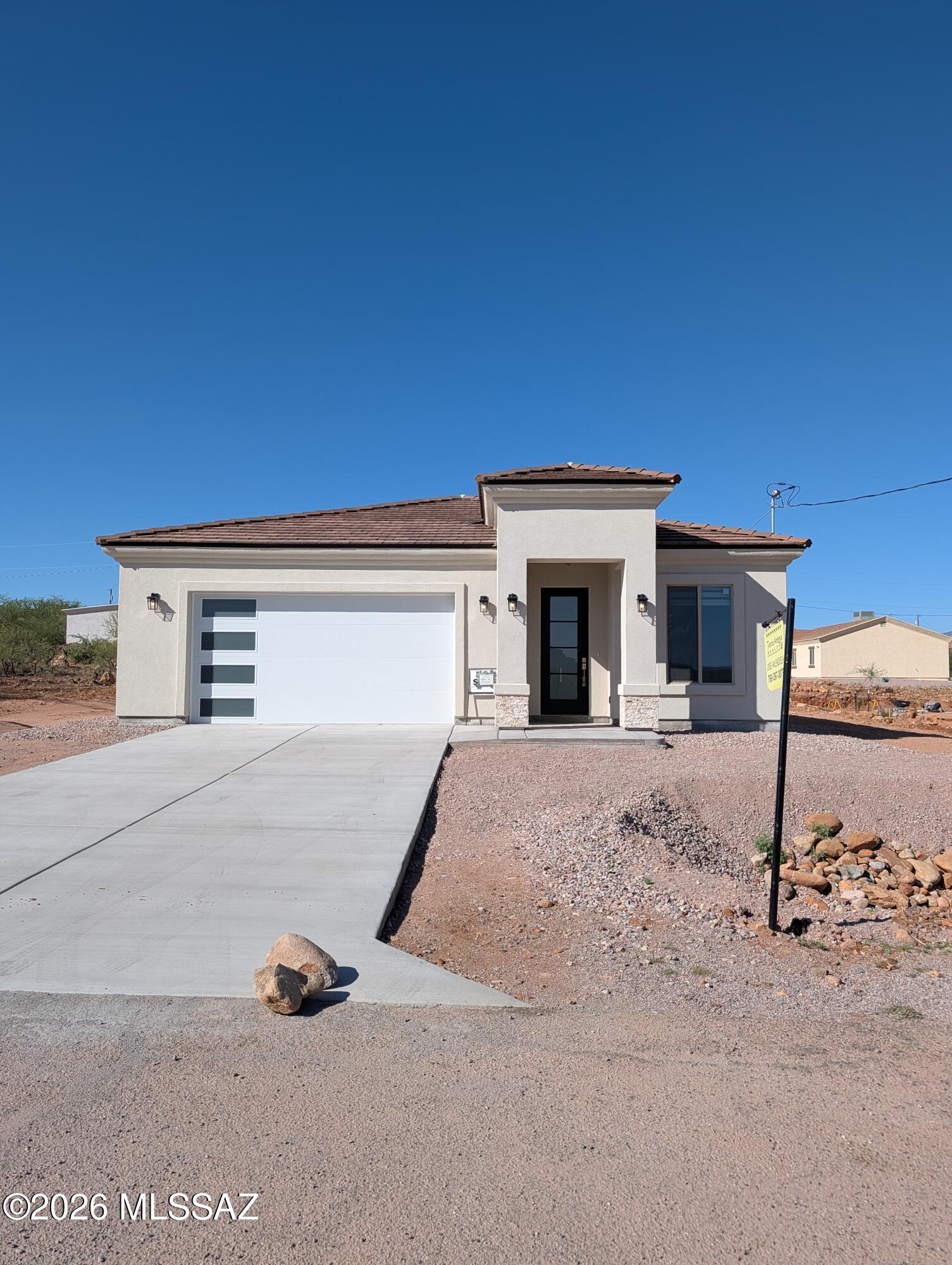 Owner / Agent - Enjoy beautiful mountain views from this stunning new home in Rio Rico! This single-story three bedroom, two bath home offers 1,639 sq ft with an open-concept layout, tile throughout, and blinds already installed. The upgraded kitchen shines with gorgeous waterfall granite countertops, stainless steel appliances, and a spacious design that opens to the main living area. Beautifully finished bathrooms add a custom touch, while the long extended driveway offers extra convenience and curb appeal. Stylish, functional, and surrounded by scenic views, this Rio Rico home is ready to impress.