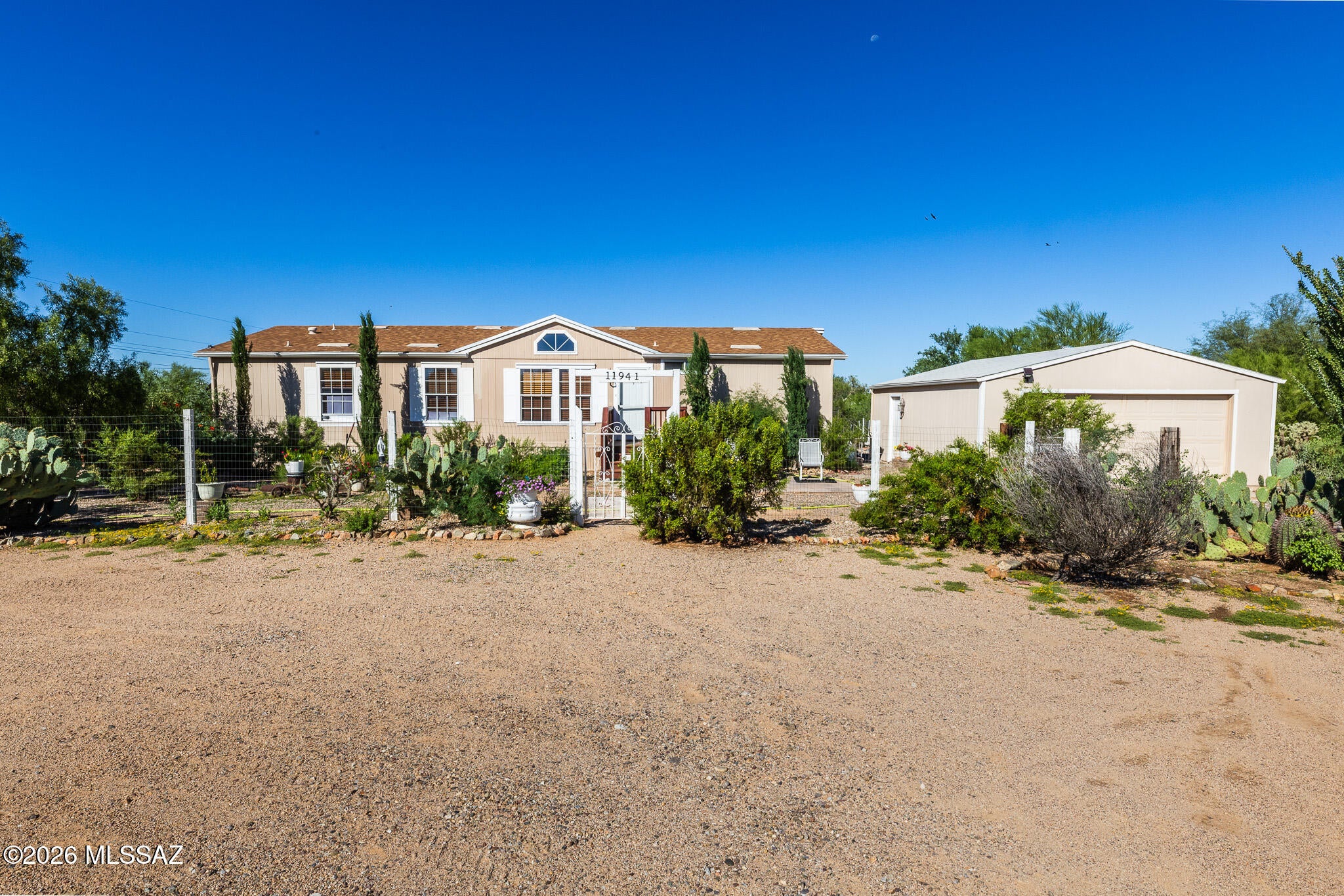 Welcome to spacious desert living on a full acre! This 4-bedroom, 2-bathroom manufactured home offers the perfect blend of comfort, privacy, and outdoor living, with beautiful mountain views and plenty of room for horses, vehicles, and recreational toys.
The inviting front yard features a combination of mature landscaping and natural desert surroundings, complemented by a circular driveway and picturesque mountain views. The  backyard is great for entertaining and horses. Step inside to a bright and spacious interior featuring high ceilings, a comfortable floor plan, and a combination of laminate and carpet flooring. A new HVAC system provides added peace of mind and year-round comfort.

The property also features a detached 2-car garage, offering convenient parking and additional storage space. With land, mountain views, equestrian amenities, and ample outdoor space, this property offers a unique opportunity to enjoy the best of desert-country living.