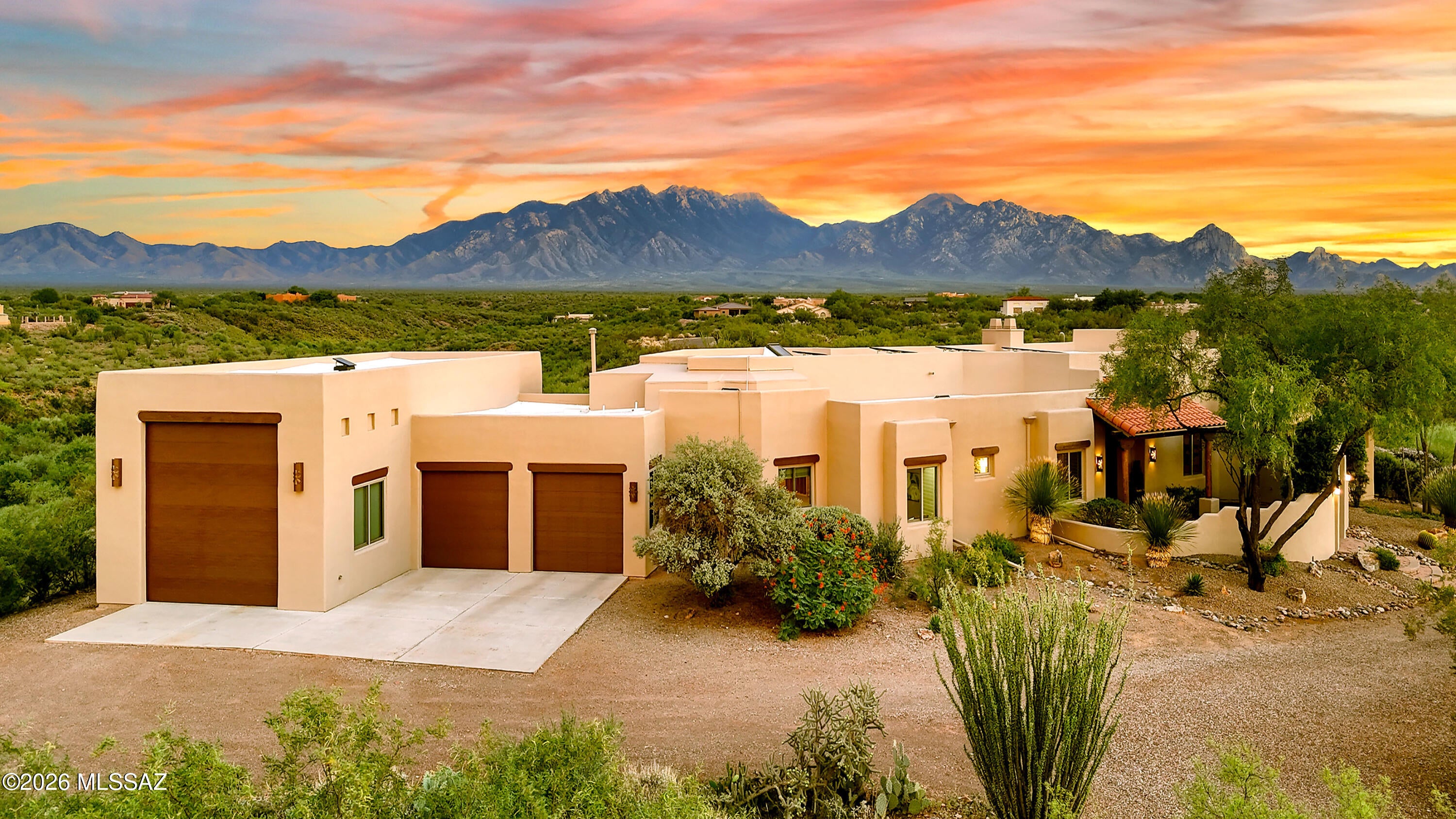 Perched on over 3 private acres with nothing behind you but open desert and the towering Santa Rita Mountains, this extraordinary Green Valley estate delivers a rare combination of privacy, elegance, and effortless indoor-outdoor living. A gorgeous front courtyard adds tremendous curb appeal and immediately  impresses guests.  Inside, a huge great room is anchored by a wall of glass that frames the mountains from nearly every living space. Soaring ceilings and rich architectural detail bring elegance throughout, while spacious living and dining areas make formal entertaining feel effortless. The kitchen features a large center island, abundant counter space, and even more mountain views, with a cozy breakfast area for quieter, more intimate mornings. The backyard is nothing short of spectacular.  Framed by sweeping mountain vistas, it unfolds like a private resort -- the kind of space where you'll naturally find yourself lingering, morning coffee in hand or glass of wine at sunset. Here, space and privacy are in abundant supply. An outdoor BBQ area anchors the dining patio, effortlessly extending the home's living space into the open air, while multiple thoughtfully designed gathering areas set the stage for intimate conversation or lively entertaining. As evening falls, a glowing fireplace casts a warm, inviting ambiance. And with generous space still to spare, there's room to dream -- whether that's a children's play area, a sculptural pool, or a secluded hot tub retreat. Back inside, A private den sits adjacent to the main living area, can be closed off for quiet focus, and overlooks the front courtyard for a daily dose of inspiration. Two additional bedrooms offer the flexibility to accommodate whatever life brings...guest rooms, a music room, a home theater, or a school room. The primary suite is a true retreat, bringing the beauty of the Santa Ritas inside from the moment you wake.
This home also offers standout features you won't find everywhere: New Anderson windows, durable, energy-efficient ICF (Insulated Concrete Form) construction, owned solar for true green living, and a 50-foot RV garage with 50 amp service and fully tricked out in style for the ultimate toy collector, fitting up to eight cars, all of your outdoor adventure gear, and/or your treasured RV!
With absolute privacy, unmatched mountain views, true green features and that unique garage, you won't find another home like it in Green Valley.  Time to make your dreams come true!