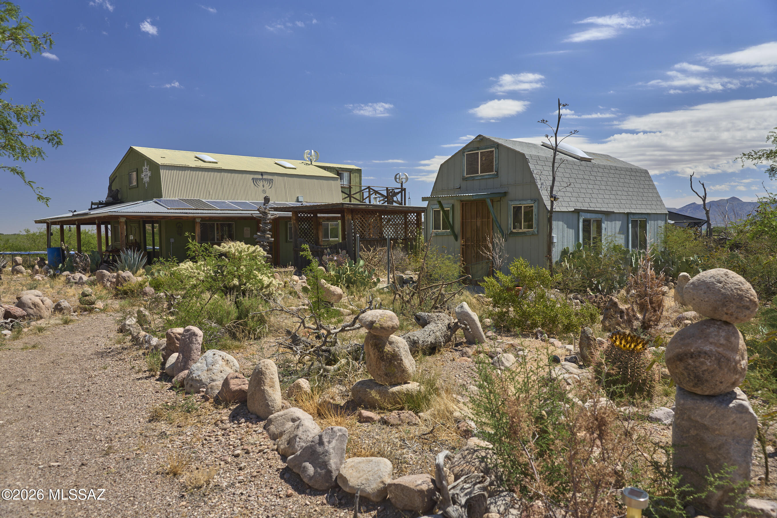 Just outside of Horseshoe Canyon in the San Simon Valley of Southeast Arizona, this unique 30-acre off-grid property offers space, privacy, and stunning mountain views. The property features a 1,084 sq ft main home, a 576 sq ft guest house, and a 2,400 sq ft utility building, providing flexibility for homesteading, hobbies, workshops, guests, or creative pursuits. Powered by solar energy and serviced by hauled water, this property is ideal for those seeking greater self-sufficiency. Located near Portal, AZ, a world-renowned destination for hiking, birding, wildlife viewing, and some of the darkest skies in the country (Bortle 1-2), this is an exceptional opportunity for an artist retreat, nature lover's getaway, or peaceful escape from city life. Experience beauty, quiet, and freedom.