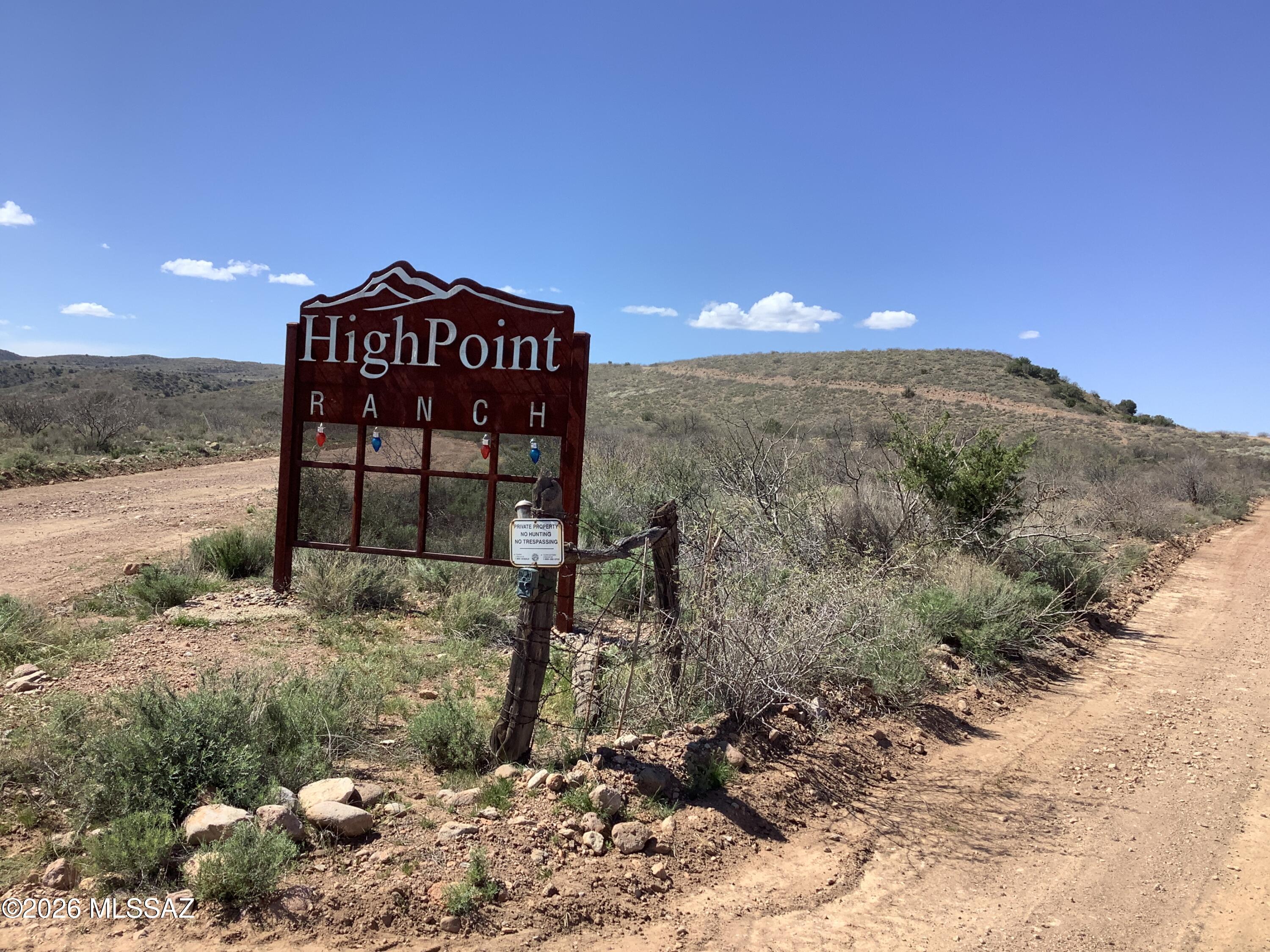 Beautiful lot with rolling hills and 360-degree mountain views.  Two driveways have been graded in that leads to a nice cleared spot with 8'X8' storage building with attached 400' of shade structure. There is a (3) 55gal barrel septic system with 40' of leach line which is perfect for camping/RV. There is a 1100-gallon water storage tank on stand for hauled water with solar panels for water pump.  Another bonus is the 60'X60' fence in coral either for livestock - dogs- or even children play area.  This property is in a gated community so you will need agent to show property.
