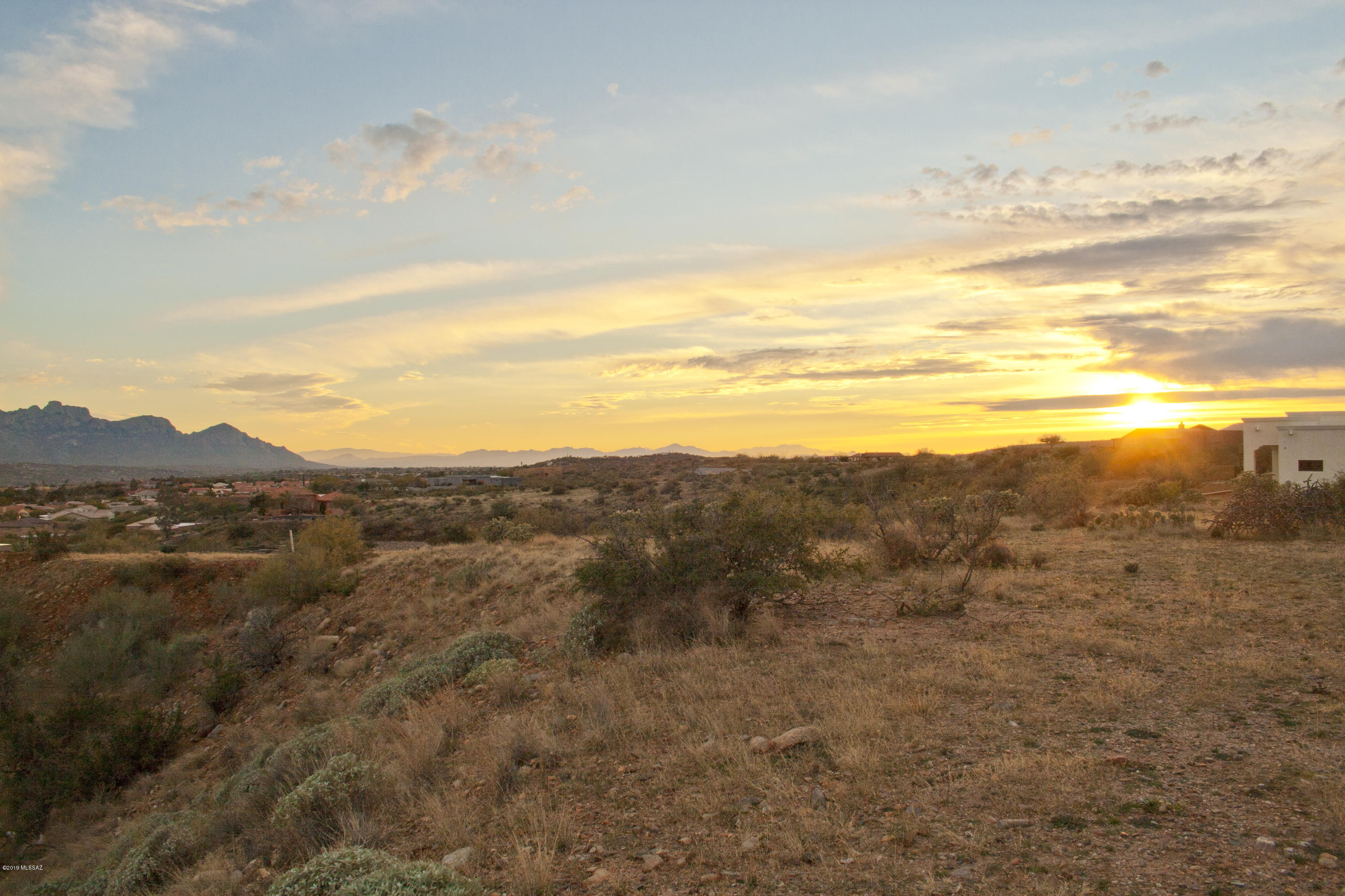 This fantastic custom lot offers superb views of the Catalina Mountains from its private location secluded from other homes. Located off a short section of dirt road, this peaceful setting has a bit more of a rural feel to it, partly due to the quite large 1.80 acre lot. While some site preparation may be necessary to build this lot up, the lower price point allows for this additional site prep. Electric lines are to the lot. Enjoy being just a minute away from Saddlebrooke itself, nearby to city amenities, and NO HOA fees or CC&R restrictions. Minor deed restrictions.