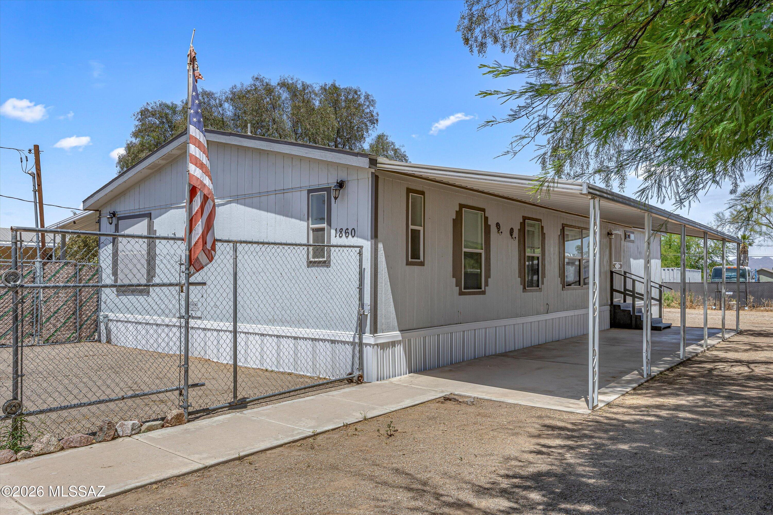 Looking for space, comfort & a little room to roam? This 4 bedroom 2 bath manufactured home offers a desirable split bedroom floor plan perfect for added privacy. The spacious kitchen is the heart of the home featuring plenty of counter space & cabinets, a center island, breakfast bar & cozy dining nook ideal for everyday living & entertaining. Sitting on a generous 0.296 acre lot step outside and enjoy covered patios on both sides of the home, giving you plenty of options for relaxing & just soaking in those Arizona evenings. The spacious lot has tons of potential, whether you've been dreaming of a garden, extra outdoor living space or simply room to spread out. If you're looking for a property with flexibility, functionality, and outdoor potential, this one is definitely worth a look!