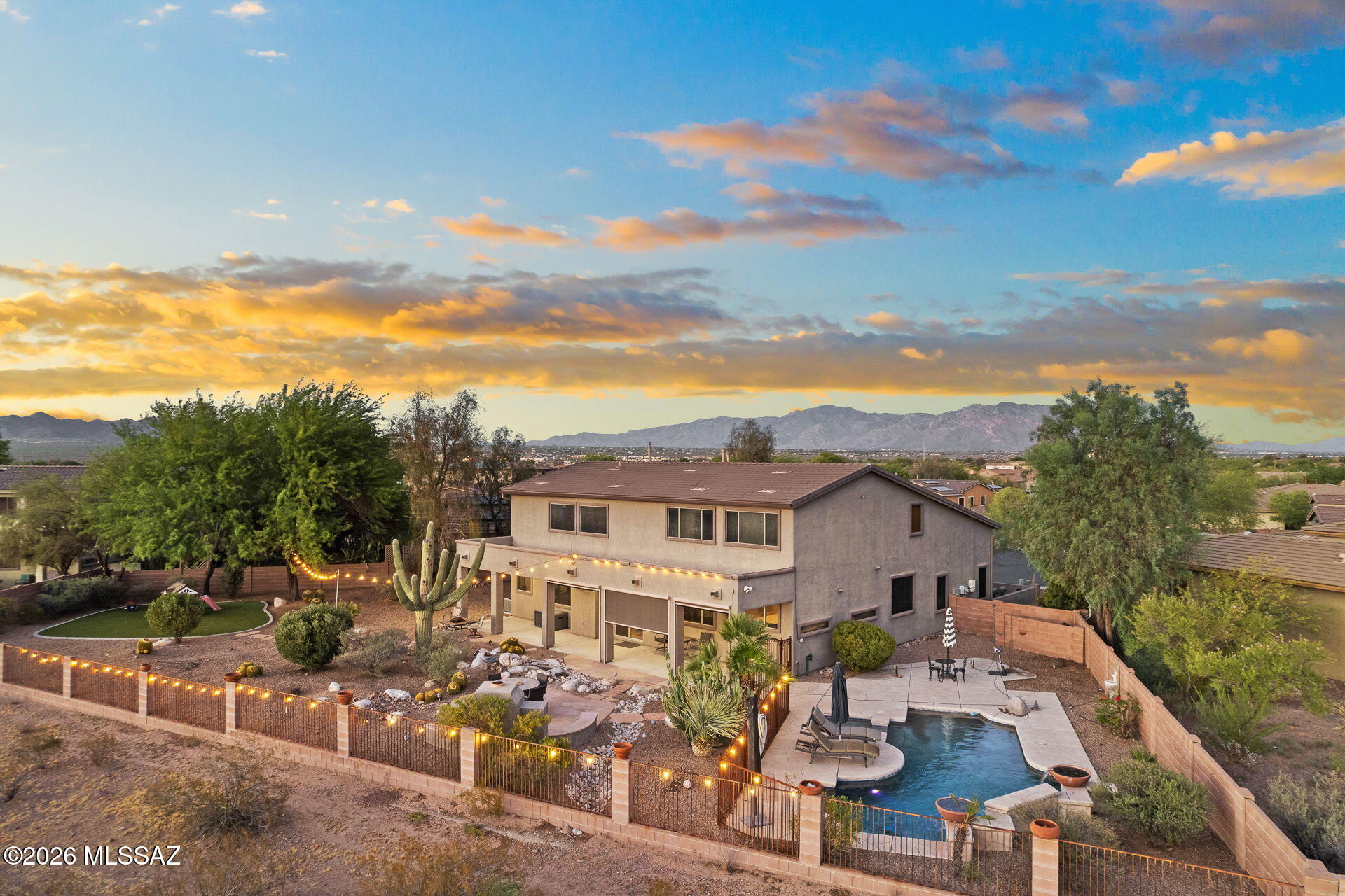 Privacy, views & versatile living spaces define this spacious Ironwood Reserve home. Situated on a quiet cul-de-sac with no neighbors behind, this 4,581 sq ft residence features soaring ceilings & a flexible floor plan. The main level offers a gourmet kitchen, travertine tile, a dedicated office with private bath, wet bar, powder room, generous living spaces & custom decor details. Upstairs, enjoy a spacious media/game room & private primary suite. The backyard is designed for Arizona living with a pool, spa, waterfall features, turf, large covered patio & striking Sombrero Peak views. double side gate provides access for recreational vehicles! The owned solar adds HUGE energy savings & have had $26 electric bills...even in the Summer!   Gated community just 9 minutes from I-10