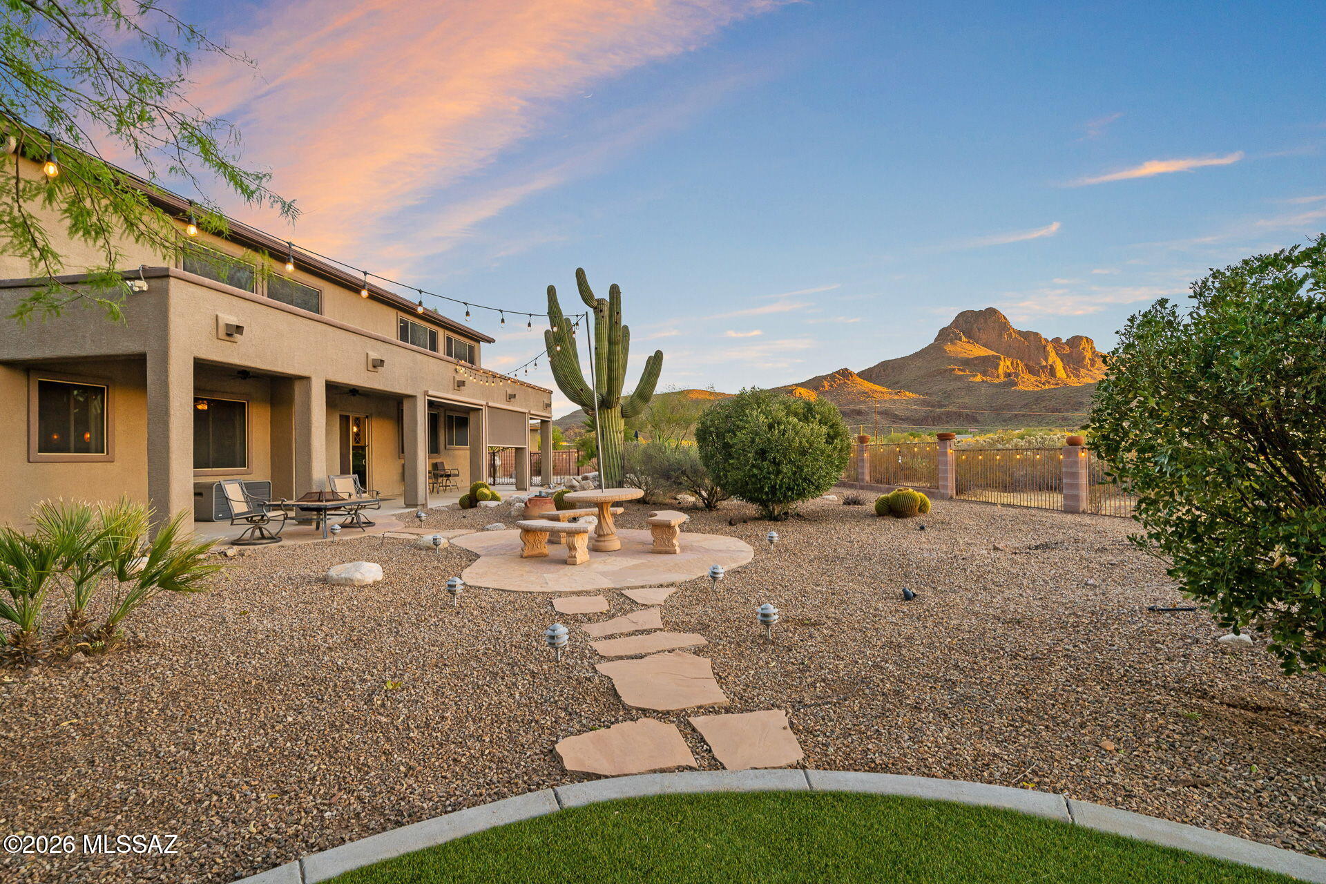 Privacy, views & versatile living spaces define this spacious Ironwood Reserve home. Situated on a quiet cul-de-sac with no neighbors behind, this 4,581 sq ft residence features soaring ceilings & a flexible floor plan. The main level offers a gourmet kitchen, travertine tile, a dedicated office with private bath, wet bar, powder room, generous living spaces & custom decor details. Upstairs, enjoy a spacious media/game room & private primary suite. The backyard is designed for Arizona living with a pool, spa, waterfall features, turf, large covered patio & striking Sombrero Peak views. double side gate provides access for recreational vehicles! The owned solar adds HUGE energy savings & have had $26 electric bills...even in the Summer!   Gated community just 9 minutes from I-10