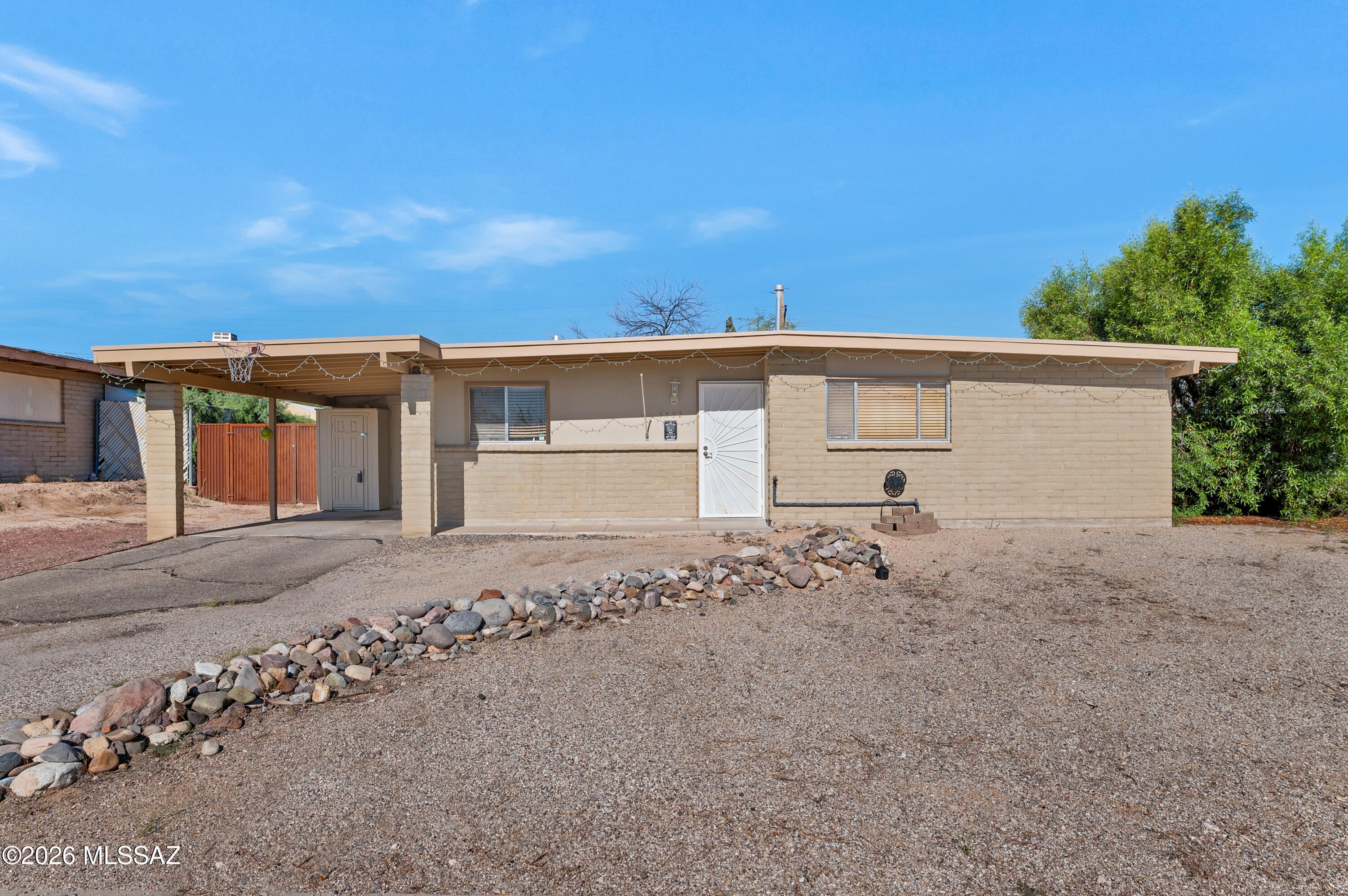 Ranch-style home with 3 bedrooms, 2 bathrooms, and an open floor plan. The kitchen has been updated with new cabinets, countertops, and appliances. Recent improvements also include an upgraded 200-amp electrical service, new PEX plumbing, a 2024 water heater, and new vanities in both bathrooms. new toilet in primary bath,  French doors in the primary bedroom and living room provide access to the backyard. The backyard offers privacy with no direct rear neighbors and includes an optional metal storage container for additional storage or workspace. One-car carport. No HOA. Conveniently located near Lincoln Park, Lakeside Lake, and Pima Community College East Campus.