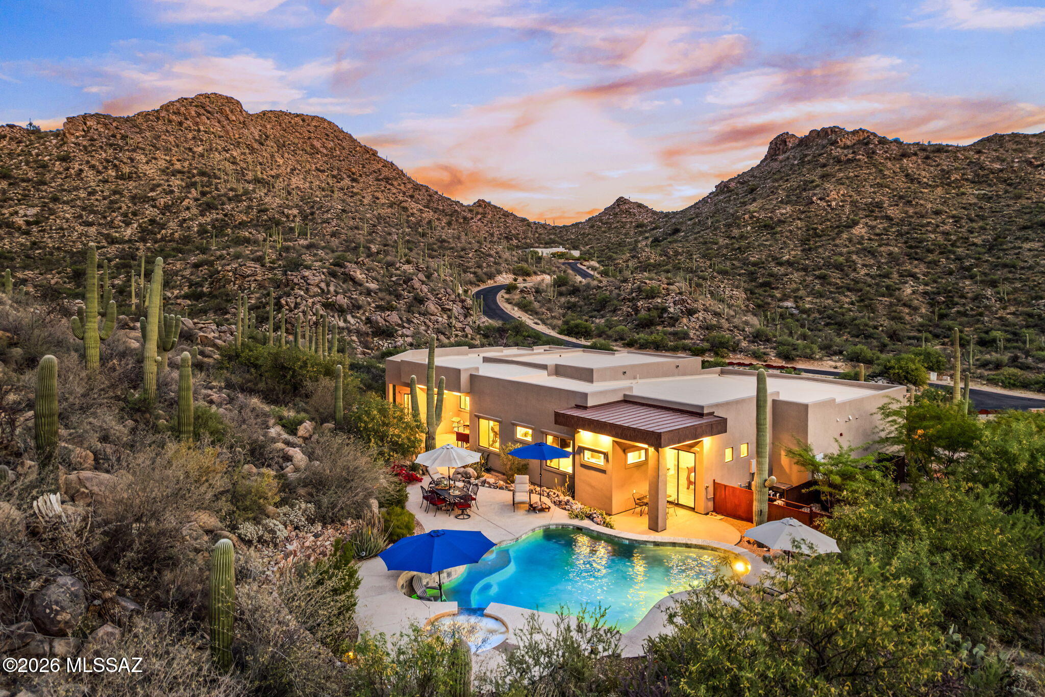 Tucked into the Tortolita Mountains within the exclusive Canyon Pass at Dove Mountain, this elevated 1.6-acre estate offers a private, resort-style lifestyle surrounded by breathtaking desert beauty. Designed for those who value serenity and sophistication, the property provides seamless access to hiking, biking, and the outdoor lifestyle that defines Southern Arizona living. Spanning approximately 3,497 square feet, with an additional 1,178-square-foot attached casita (nearly complete), the home delivers exceptional flexibility for guests, multi-generational living, or a private retreat. A split-bedroom layout of five bedrooms and five bathrooms ensures both comfort and privacy. Inside, soaring ceilings and expansive open-concept spaces create a light, airy atmosphere ideal for both comfort and privacy.
Inside, expansive open-concept spaces create a light, airy atmosphere ideal for both everyday living and upscale entertaining. The chef's kitchen is a true showpiece, anchored by a dramatic 17-foot granite island and equipped with premium Viking appliances, custom cabinetry, and a walk-in pantry, perfect for hosting gatherings or intimate dinners.
The primary suite offers a spa-inspired escape, complete with a fireplace lounge, dual custom closets, and a luxurious bath featuring a multi-jet shower, soaking tub, and private patio access, creating a true sanctuary within the home.
Step outside to experience resort-style living at its finest. The extended north-facing patio is designed for year-round enjoyment, featuring integrated heating, lighting, and multiple seating areas. A stunning heated pool and spa with waterfall and lagoon-style seating set the stage for relaxation, while the fully equipped outdoor kitchen, fire features, and desert landscaping create an entertainer's dream--ideal for sunset evenings, stargazing, and unforgettable gatherings.
Additional features such as a spacious three-car garage, advanced insulation, whole-house water filtration, and surround sound enhance both comfort and convenience.
Blending modern Southwest design with refined coastal influences, this home offers a rare opportunity to enjoy elevated desert living in one of Dove Mountain's most prestigious gated communities - where privacy, luxury, and lifestyle converge.