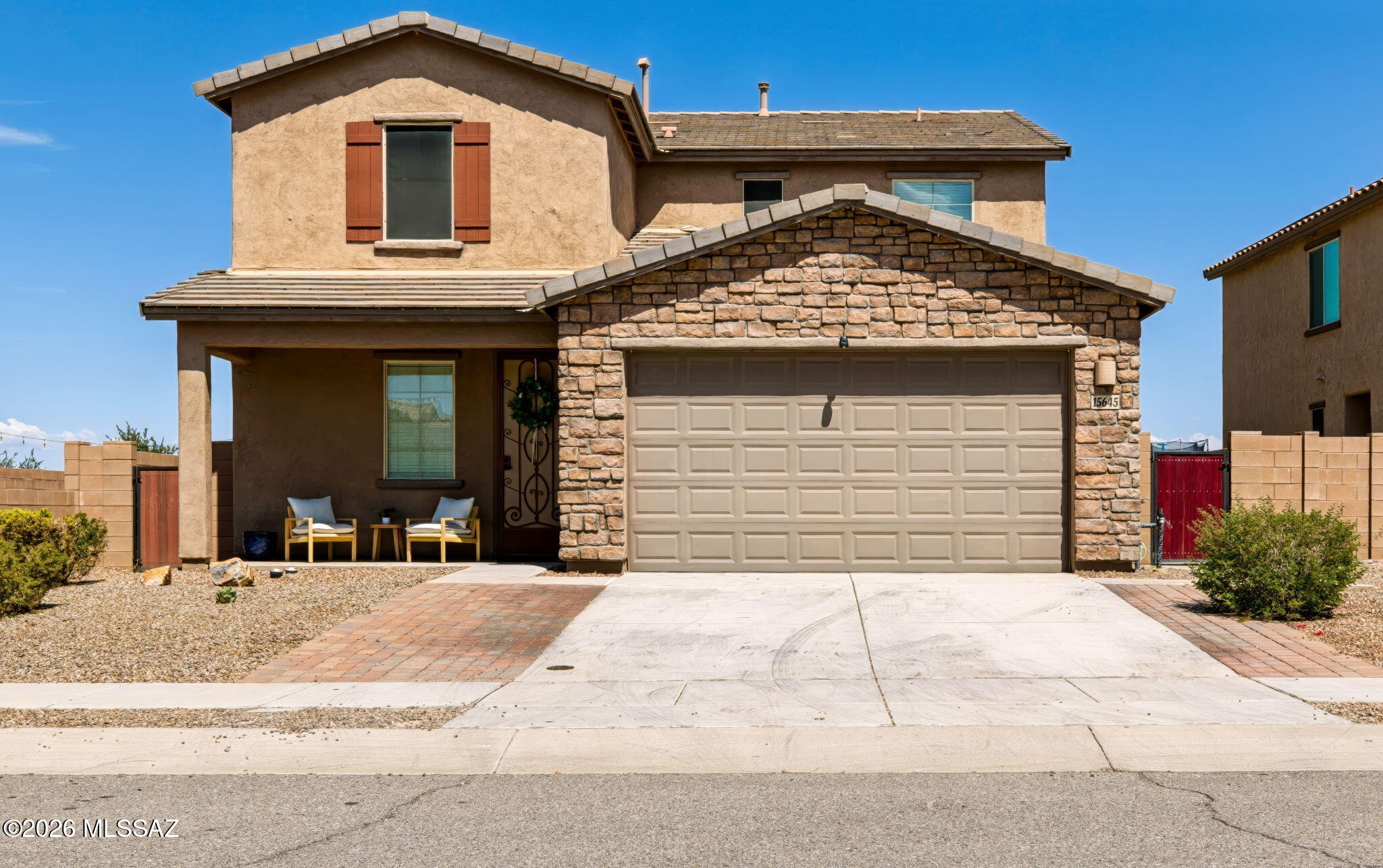 Looking for something special in Rancho Sahuarita? This NextGen home is the one! This spacious and thoughtfully designed residence offers TWO HOMES UNDER ONE ROOF, creating an exceptional opportunity for multigenerational living, a private home office, ultimate guest quarters, or whatever fits your lifestyle. From the moment you arrive, the curb appeal impresses with an elevated stone facade, welcoming front patio, and an expanded driveway with additional pavers. Inside, fresh paint and brand new carpet creates a bright, move in ready feel, complemented by upgraded plank ceramic tile flooring.  The spacious kitchen designed for both everyday living and entertaining, featuring a large granite island, abundant cabinetry, and an oversized pantry. Upstairs you will find a versatile loft and four spacious bedrooms, including the beautiful primary suite with a huge spa like shower that creates the perfect retreat at the end of the day. The true showstopper is the NextGen suite located downstairs, offering an incredible level of privacy and flexibility. Complete with its own separate entrance, the suite features a private living area, kitchenette, full bedroom, full bathroom, and laundry closet. Step outside to a backyard designed for relaxing and entertaining, featuring a screened in covered patio, finished paver patio, and low maintenance turf. Whether you're enjoying a quiet morning outside or hosting, this space is ready to enjoy. Located in the amenity rich Rancho Sahuarita community which features a splash park, pools, clubhouses, gyms, parks, walking paths a lake, and planned activities for all! Come see all the possibilities this exceptional home has to offer!