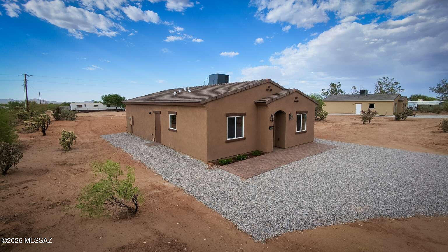 Brand new construction on over an acre with breathtaking desert and mountain views. Situated adjacent to Arizona State Trust Land, this property offers the rare benefit of no neighbors directly in front of the home, providing added privacy and unobstructed open-space views. Thoughtfully designed with modern finishes, an open-concept layout, and plenty of room for horses, RVs, toys, or future improvements. Enjoy the peace and freedom of rural living while remaining within commuting distance of Tucson. A unique opportunity to own a new home surrounded by the beauty of the Sonoran Desert.
