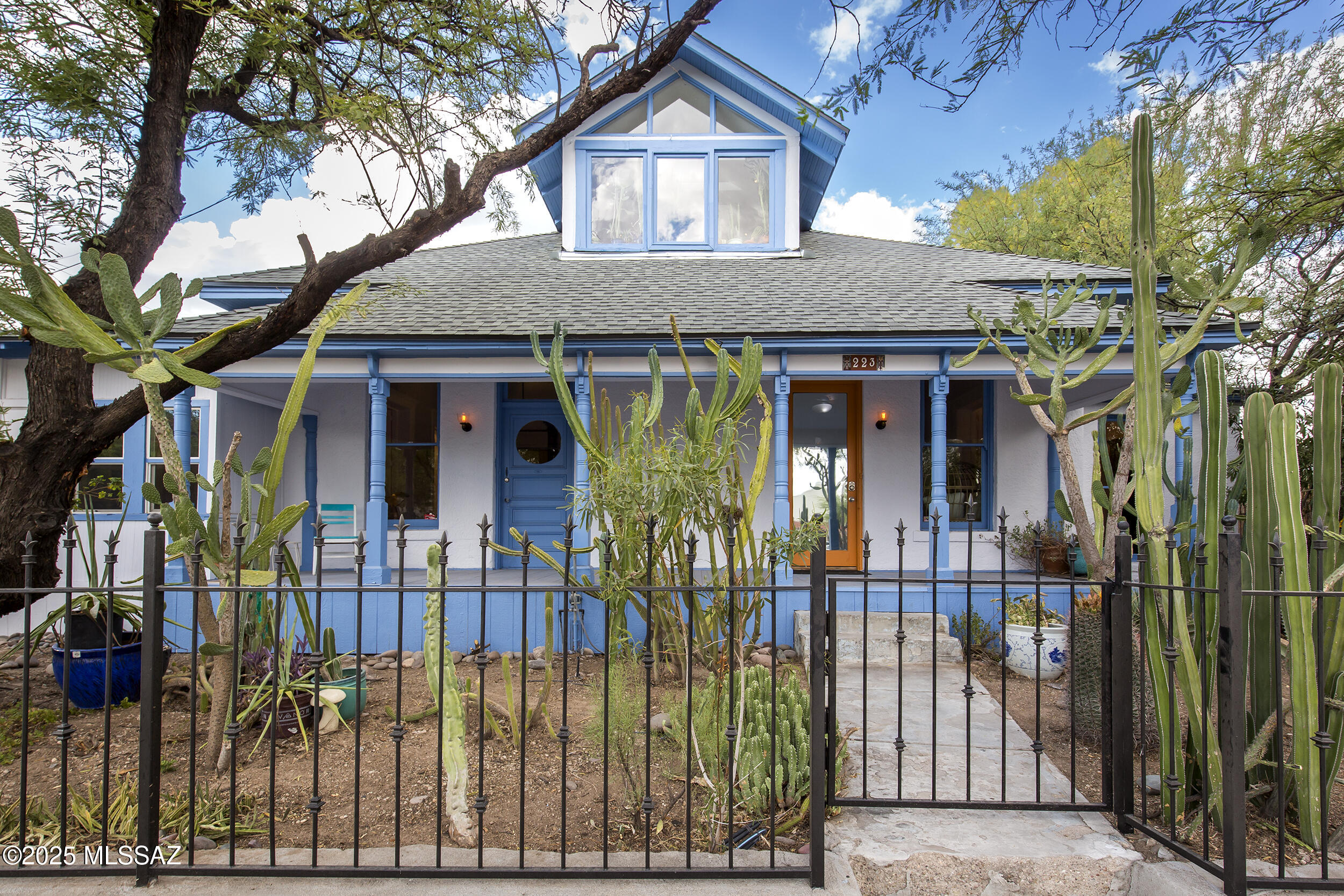 Stunning home in the heart of Tucson's Armory Park Historic District, perfect for experiencing the very best of downtown living. Close to everything, this gorgeous 1898 territorial colonial revival brick home has 3 bed/2.5 baths in the main house and a beautiful 1 bed/1 bath guest unit. Features wood floors throughout, very high ceilings, large windows, oversized thresholds, French doors, spacious kitchen, 2 gas fireplaces, Venetian plaster, exposed red brick walls, three porches, an Italian glass tile shower, and a large soaking tub. 
Perfect for entertaining, this spacious home features countless delightful details. The second floor is light-filled with a large north facing deck, sunset views and bonus space not counted in square footage. Home has a new roof, new HVAC, fresh paint inside and out, ample closets and storage areas, and a basement. Surrounded by mature trees, an incredible front yard cactus garden and a large backyard with a convenient vehicle gate. Delightful guest unit has a private front porch entrance and can be rented out, used for multi-generational housing or incorporated into the main house. An incredible and unique historic showpiece.