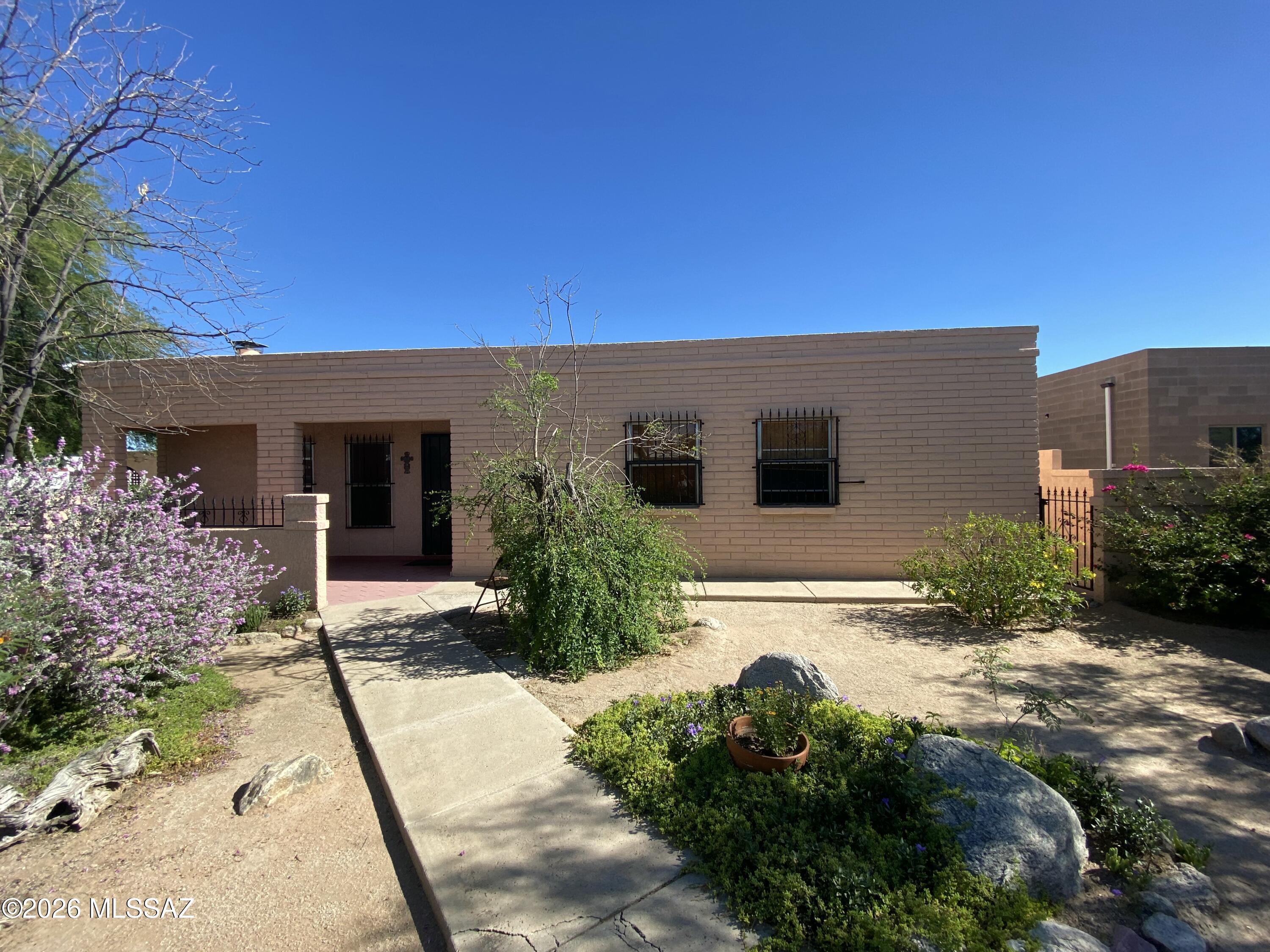 Beautiful ASIS slump block, custom built home with lots of mature fruit bearing trees, an orange, apricot, and grapefruit tree.  Nicely landscaped with extra storage and extra bonus rooms.  A Workshop, Bonus Room(good man cave or she shed), metal storage shed, and storage closets in this incredible and large back yard space.  
They don't make homes like this anymore...come see!  Its ready for you to move in!   Refrigerator, Newer Washer and Dryer will remain with the home.  ON SUPRA KEYSAFE, Go show!  
Early Bird Escrow has already begun with Pioneer Title Agency - Team Angela at 430 N Tucson Blvd.