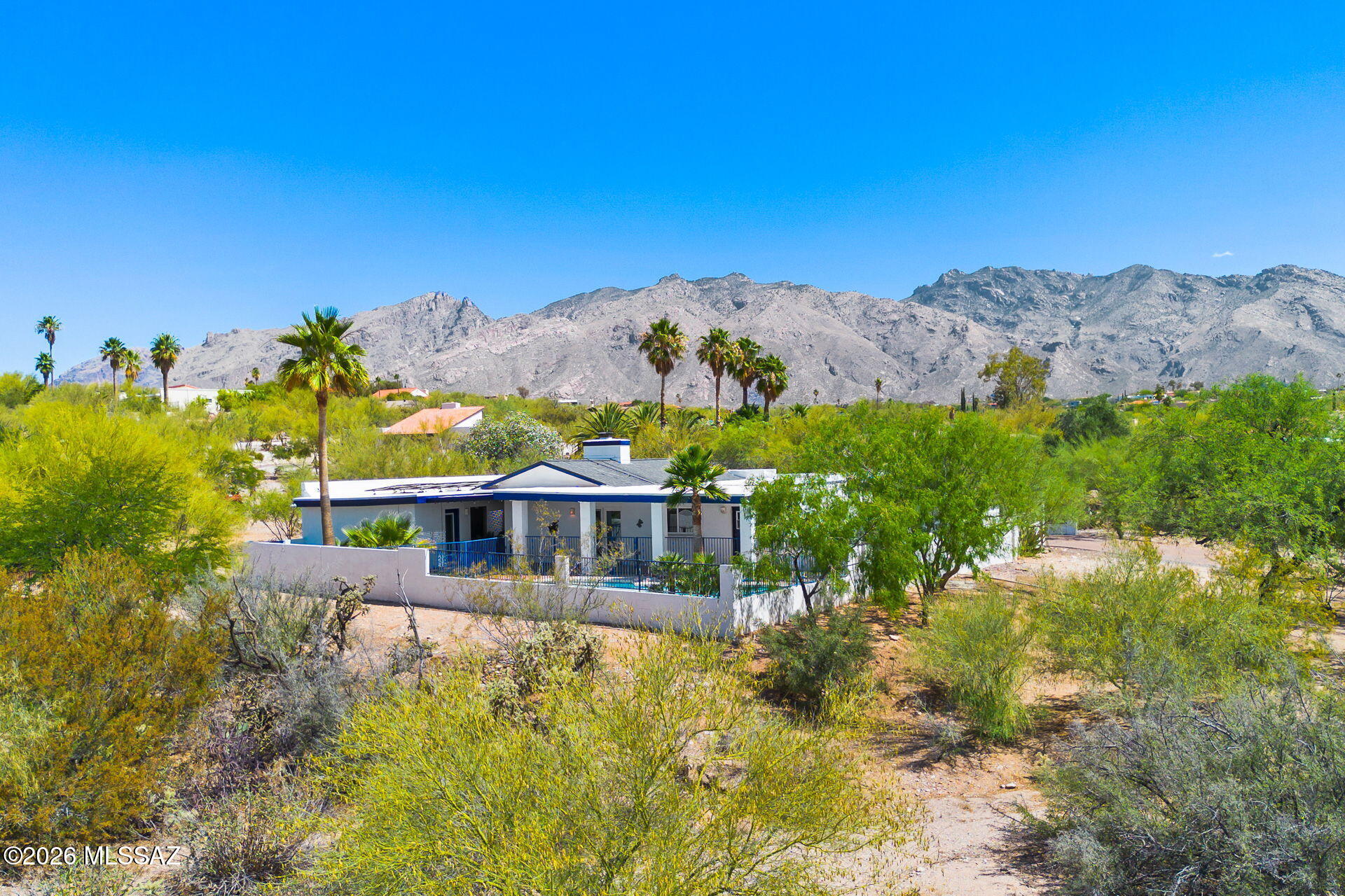 Tucked away on a private lot, 4581 N Avenida Del Cazador offers a highly accessible Catalina Foothills location paired with peace and quiet. Set far back from the road down a dedicated paver driveway, this classic single-story masonry stucco home is completely surrounded by desert open space. This single-story home features 2,234 square feet with no interior steps. 

Inside, you will notice fresh neutral paint, Saltillo tile in the main living areas, soaring ceilings, and a two-way stone fireplace provides a natural separation between the main living spaces.
Outside, the fully fenced backyard is low-care and ready to enjoy, featuring mature palm trees, artificial turf, and a newly plastered tailored for Tucson summers. The attached two-car garage, two additional carports and extra space around the property provides excellent coverage for vehicles.  Don't miss the generous space on the west side of the property offering excellent potential for expanding your outdoor living area or adding other improvements.

Many functional upgrades have recently been made to the home, including a new roof (2023), fresh interior paint, and new carpet in the bedrooms and hallway. Additional improvements include newer HVAC systems (2023/2015), all windows replaced since ownership, new pool tile and plaster (2026), driveway and carport enhancements, and a new Tesla solar system to maximize sustainability (2024).

This location offers incredible convenience to enjoy everything that Tucson has to offer. Access to "The Loop," a 135-mile paved multi-use path is only a mile walk or ride but also includes a parking area. Within a mile there are robust school options, including BASIS North, The Gregory School and Castehill Country Day School. Within that same 1-mile radius you will enjoy access to Whole Foods, Natural Grocers, a pharmacy, bank, fitness facilities and various retail shops. TMC is 8 minutes, Sabino Canyon is 9 minutes, and the University of Arizona is under 20 minutes.