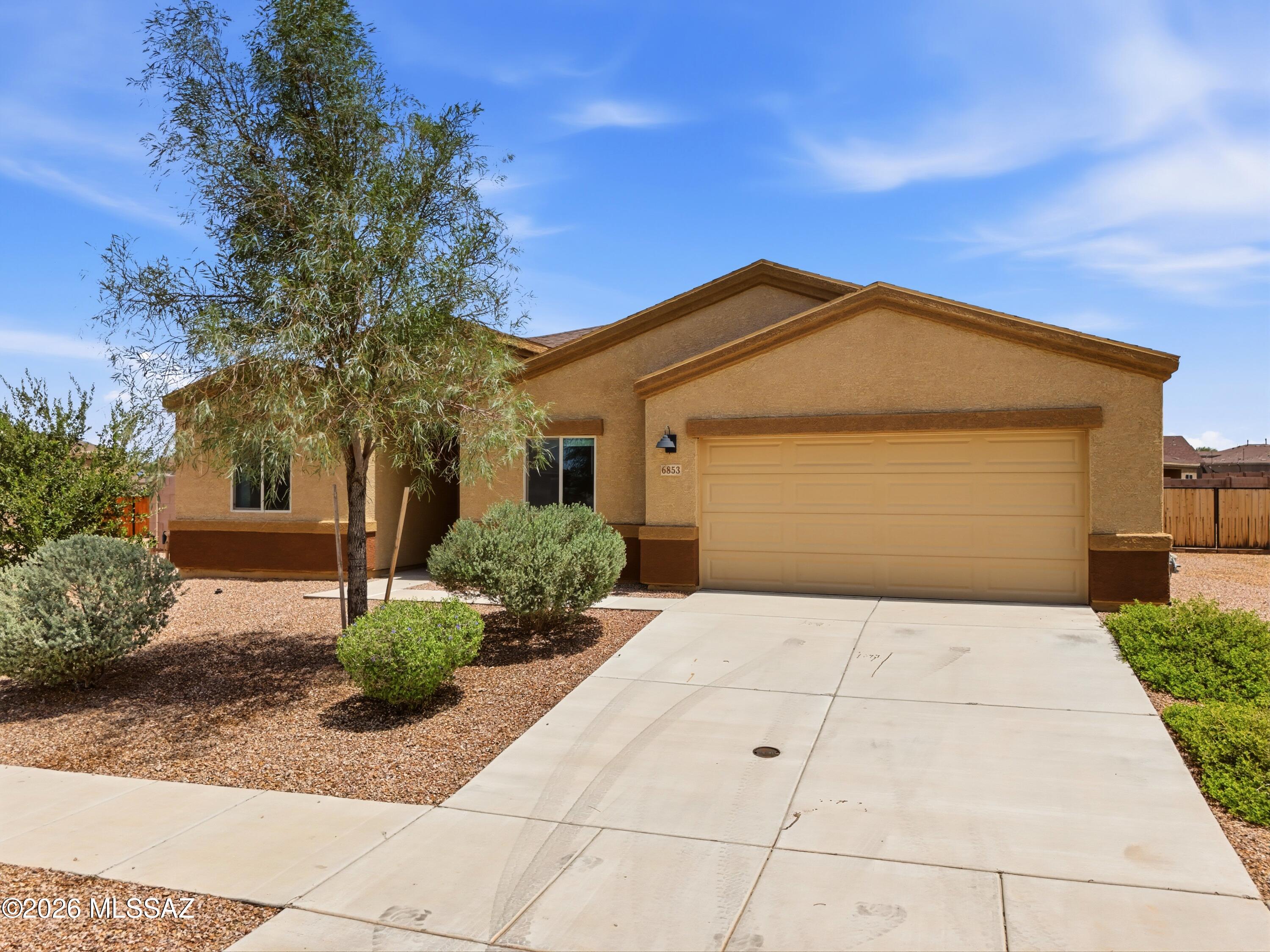 This beautiful single-story home offers 4 bedrooms, 2 bathrooms, 2,002 sq. ft., and a desirable split-bedroom floor plan. The bright and spacious great room flows seamlessly into the kitchen, creating the perfect space for everyday living and entertaining.
The kitchen features granite countertops, a large breakfast bar, abundant cabinetry, stainless steel appliances, and a gas range, providing plenty of prep and storage space.
The private primary suite includes a large walk-in closet, walk-in shower, dual vanity with granite countertops, and a generous linen area with built-in shelving.
Step outside to enjoy the spacious backyard with low-maintenance turf, perfect for relaxing or entertaining. Located in Southwest Tucson, you'll enjoy wide-open spaces, beautiful mountain views, towering saguaros, and the spectacular Arizona sunsets that make this area so special.