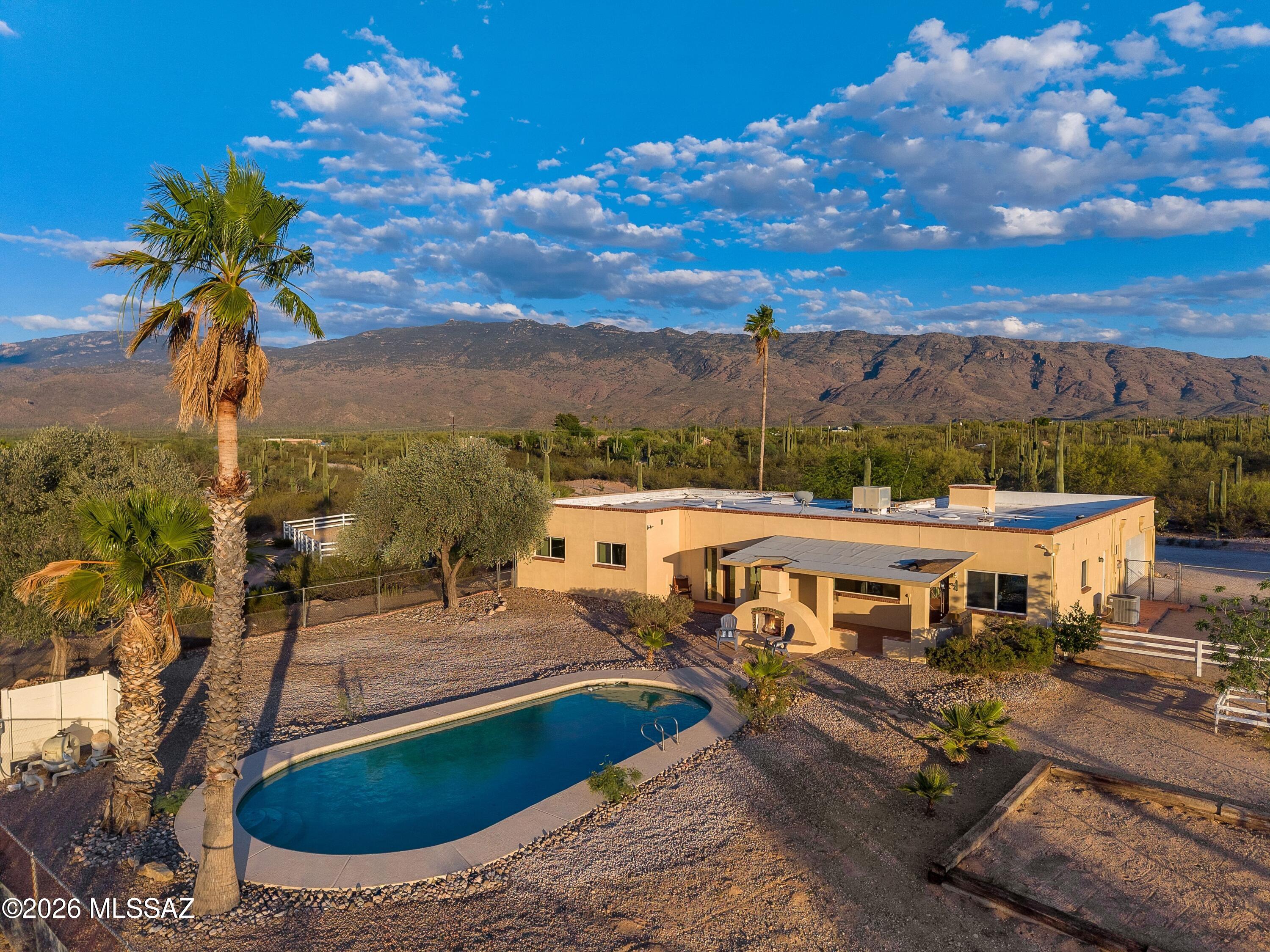 Northeast gem of a horse property surrounded by gorgeous sweeping mountain views! Situated on almost 5 peaceful acres, no HOA and in close proximity to Saguaro National Monument to ride or hike! Equipped with pastures and barn, the horse facilities are ready to meet your equestrian needs. Find upgraded finishes throughout the Hacienda-style home, including stone floors, granite countertops and french doors. Sparkling pool and outdoor living areas compliment this homestead's charm. Don't wait to experience this property's magic!