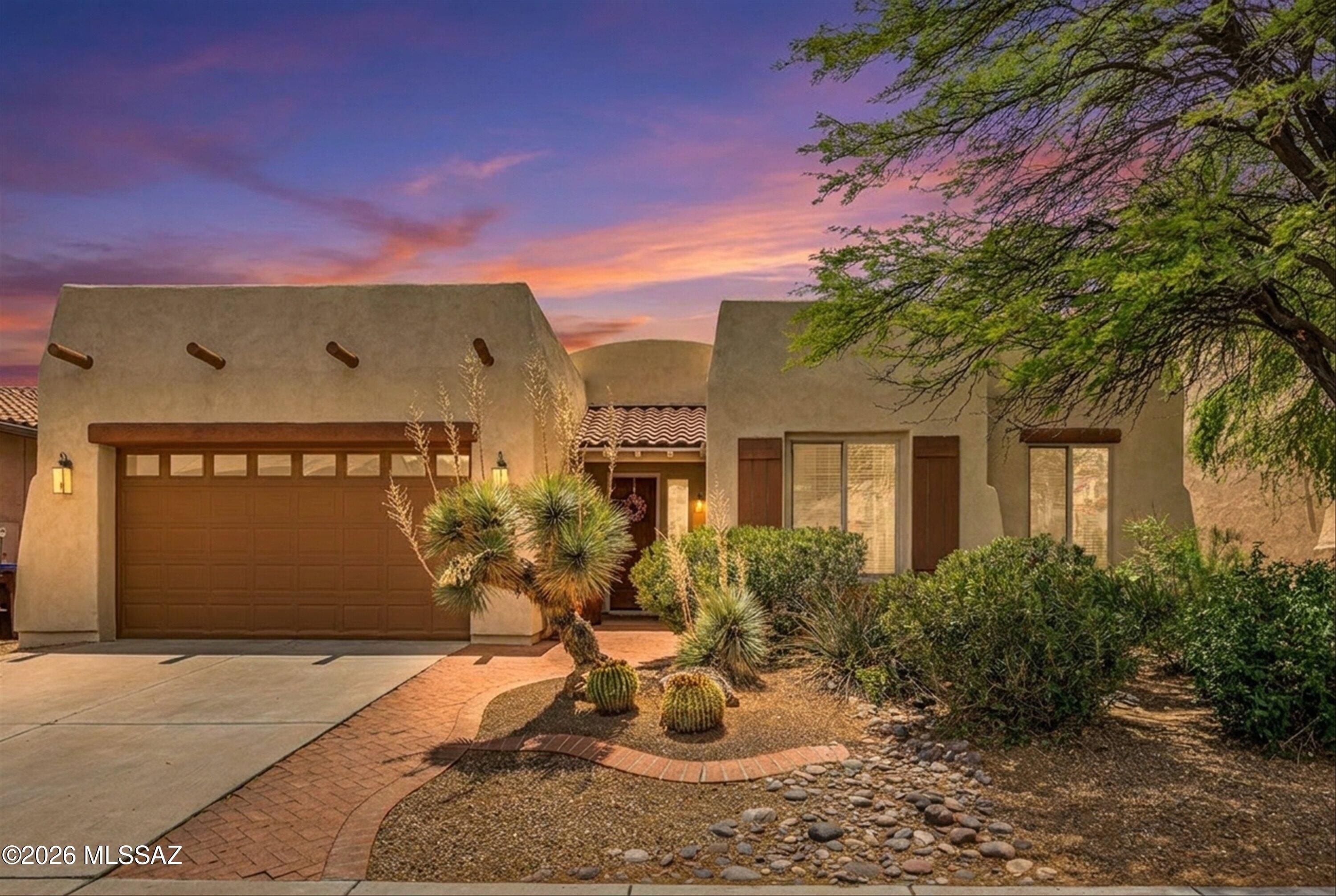 Nestled in one of Rancho Sahuarita's most sought-after neighborhoods, this beautifully maintained single-story home offers the perfect blend of comfort, functionality, and community-centered living. Surrounded by lush, established greenery, fresh exterior paint, and a newly recoated roof, this home welcomes you in with beautiful curb appeal and a warm, inviting feel from the moment you arrive.
Inside, a thoughtfully designed floor plan provides space for everyone, featuring two separate living areas and two dining spaces, ideal for both everyday living and gathering with loved ones. A cozy double-sided gas fireplace creates a natural separation between spaces while adding an inviting ambiance throughout the home.
The heart of the home extends outdoors to a private, fully landscaped backyard designed for making memories. Enjoy evenings around the fire pit, weekend barbecues at the built-in gas grill, and the peaceful atmosphere created by the beautiful rock pond and waterfall feature. The backyard offers a serene, tucked-away feel that is perfect for relaxing or entertaining.
The spacious primary suite offers a relaxing retreat, complete with a large walk-in closet, dual vanities, and a soaking tub perfect for unwinding at the end of the day. Two of the four bedrooms feature custom murals, creating charming spaces that are perfect for children's rooms, nurseries, playrooms, or creative flex spaces. New carpet in all bedrooms adds a fresh, move-in-ready touch.
Additional highlights include a three-car tandem garage with extra storage, surround sound, several newer appliances, and an updated HVAC system for added comfort and efficiency.
Located just moments from Rancho Sahuarita's exceptional amenities, you'll enjoy easy access to the lake, clubhouse with state-of-the-art fitness center, tennis and pickleball courts, splash park, mini golf, scenic walking trails, and a bark park for your four-legged family members. The nearby La Villita Community Center offers even more opportunities to connect, with events and activities designed for all ages.
This is more than just a home, it's a lifestyle rooted in connection, comfort, and community.