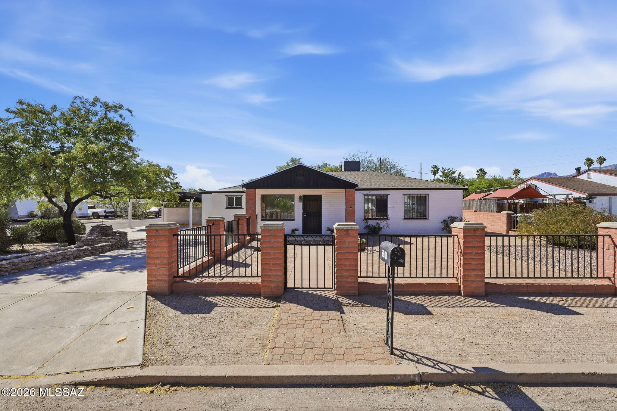Charming mid-century home in the heart of Central Tucson featuring a NEW ROOF IN 2026! Situated on a spacious .24-acre corner lot, this 4-bedroom, 2-bath residence offers a desirable split bedroom floorplan with 1,482 sq ft of thoughtfully designed living space--and no HOA.

Step inside to find a beautifully updated kitchen featuring granite countertops, glass tile backsplash, stainless steel appliances, and custom cabinetry. The great room showcases stylish wainscoting, while the primary bedroom is highlighted by warm wood beam ceilings. Built-ins add both character and functionality. 

The updated hall bathroom includes a tiled shower surround, newer vanity, fixtures, and a skylight that brings in natural light. Additional interior features include ceramic tile flooring in all common areas and the primary bedroom, dual pane windows, ceiling fans and upgraded lighting.  

Enjoy outdoor living with an extended paver patio, covered front porch with gated yard, and thoughtfully placed planters in both the front and backyard. A mature grapefruit tree adds to the charm. The property also includes a 2-car carport, storage room off the porch, and a double gate for easy backyard access. 

Conveniently located near Tucson Medical Center, shopping, dining, and everyday amenities--this home blends classic character with modern updates in a prime central location.