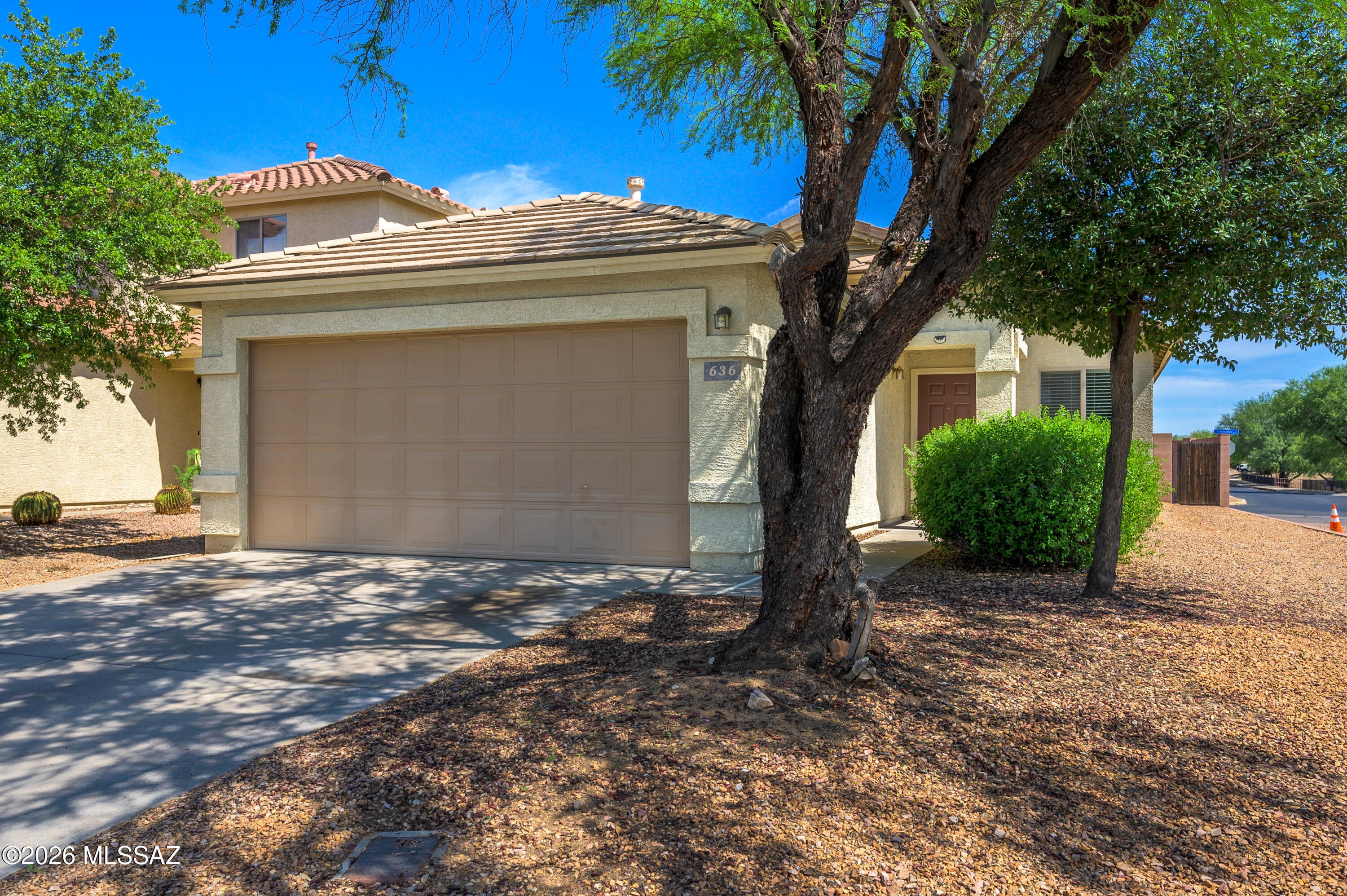 Welcome to Los Arroyos in Sahuarita, where comfort, convenience, and low-maintenance living come together. Situated in a welcoming community, this well-maintained home is just a short stroll from shopping, dining, and everyday amenities.  Inside, you'll find beautiful white tile flooring throughout, creating a bright and clean look. The well-appointed kitchen features sleek laminate countertops, stainless steel appliances, and ample cabinet space, making meal preparation both functional and enjoyable.  The spacious primary suite is tucked away at the rear of the home. The primary retreat includes a generous walk-in closet and a well-sized ensuite bathroom. Step outside to a nicely landscaped backyard featuring pavers, artificial turf, and decorative gravel for an attractive, low-maintenance outdoor living space. Additional peace of mind comes with a newer HVAC system installed in 2022.  Whether you're searching for your first home, looking to downsize, seeking a seasonal Arizona retreat, or adding to your investment portfolio, this home offers the perfect blend of style, comfort, and convenience. Don't miss your opportunity to make this charming Southern Arizona property your own!