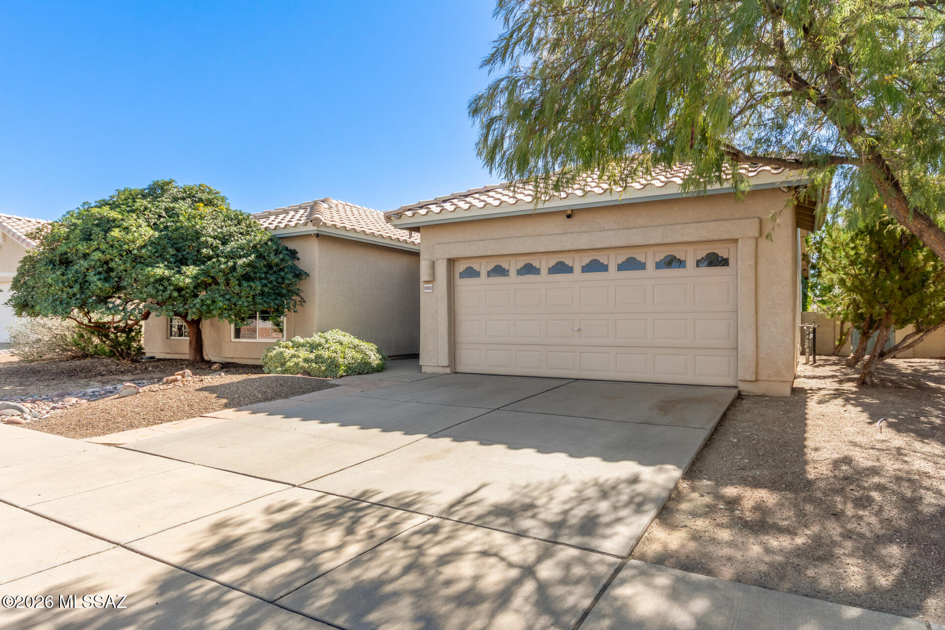 Be the proud owner of this beautiful home w/No neighbors behind! Be greeted by a 2-car garage, exceptional curb appeal, & elegant iron-work doors that open to the main entrance. Enter into an inviting foyer to see a trending palette, soaring vaulted ceilings, & abundant natural light. The bright great room provides a wonderful space for entertaining, while the spacious family room features French doors that lead seamlessly to the backyard. Chef's kitchen showcases SS appliances, rich wood cabinetry, a mosaic tile backsplash, quartz counters, & a breakfast bar. The main bedroom has a lavish bathroom w/dual sinks, a glass-enclosed shower, & a hidden walk-in closet. Enjoy the private backyard boasting a covered patio, grassy area, mature shade trees, & a flagstone seating area. Must see!