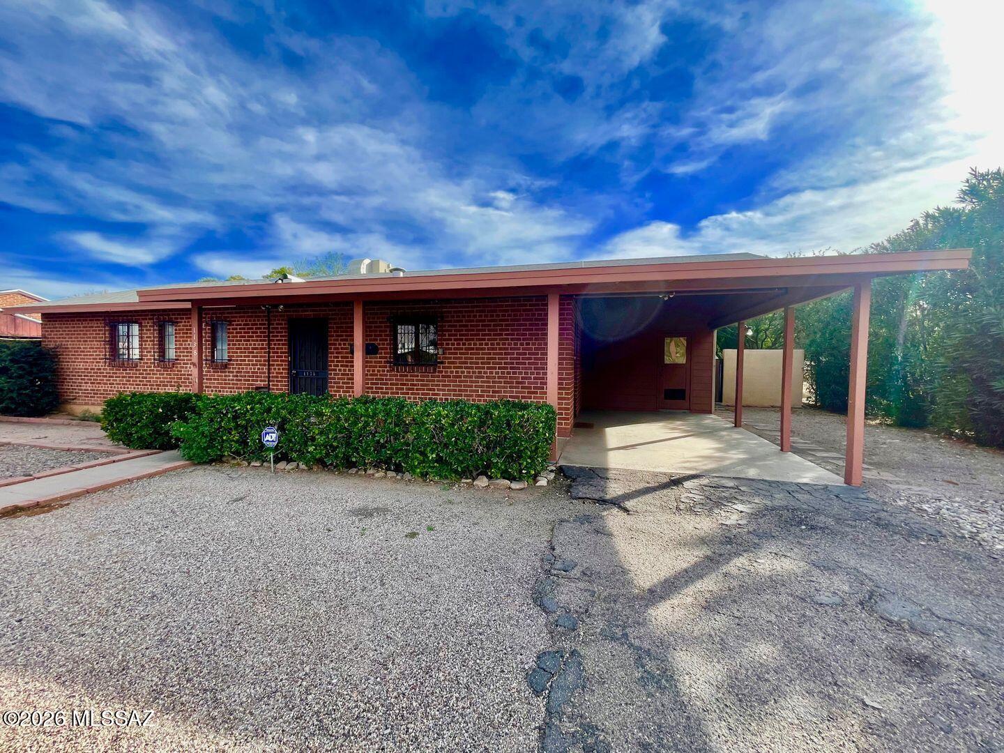 Ideal Central Location! Just one mile from UofA, minutes from Banner Medical Center and the Campbell Corridor. This well built brick home offers 1563 sq ft with 3 bedrooms, 1 1/2 baths PLUS a charming guest house with a full kitchen, full bath & it's own private entrance & yard - perfect for rental income, multigenerational living, home office or visiting guests. The main house & guest house have 18'' tile floors throughout. Separate laundry/storage room adds convenience for both units. Situated on an extra deep lot the backyard features a Ramada w/ plenty of room to entertain or garden. The lot offers an additional rear space w/ potential to build another guest house (buyer to verify). Ideal for homeowners, parents of UofA students, medical staff, or investors. New HVAC July 2025 2025
