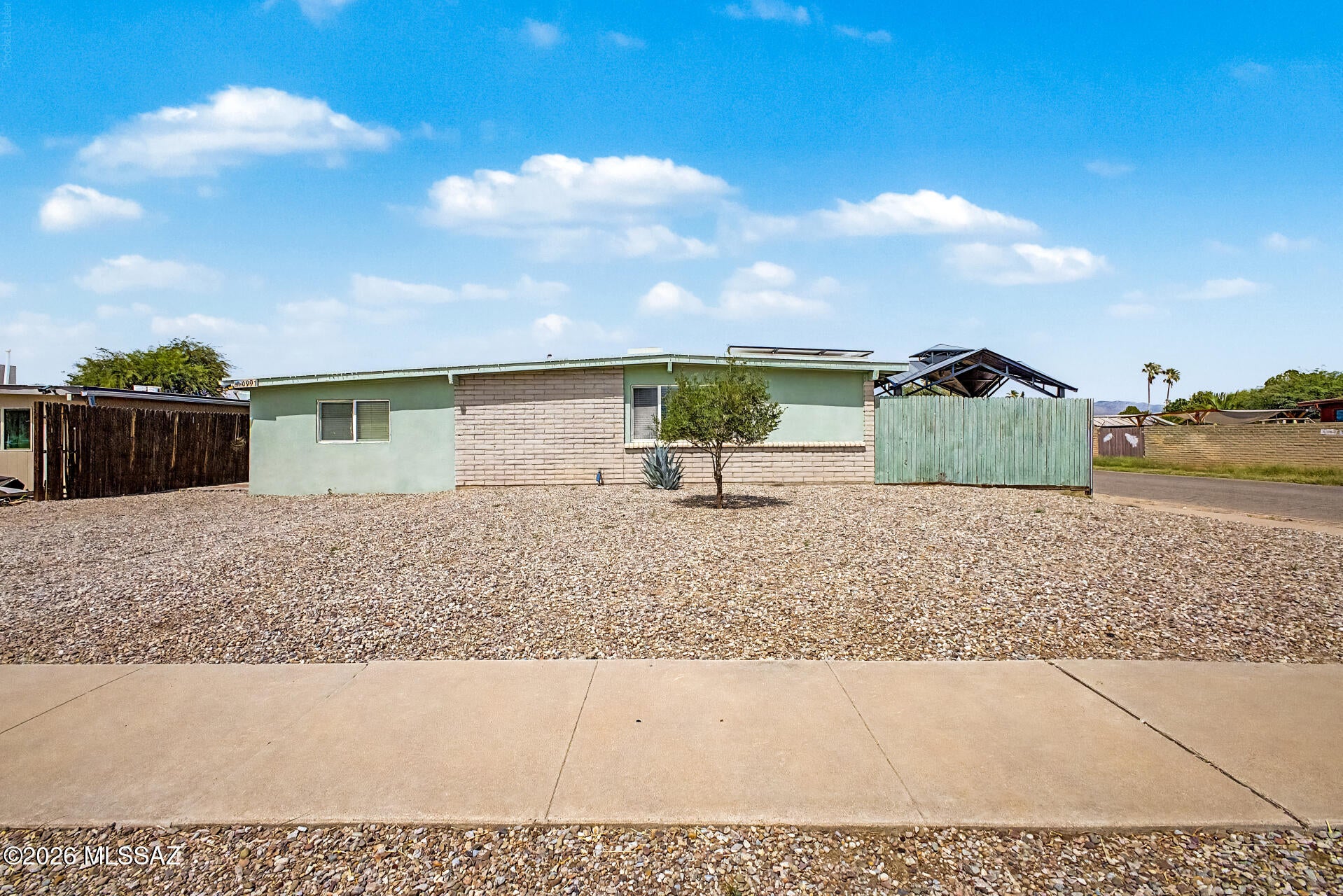 This corner lot property welcomes you with a practical RV gate and a low-maintenance yard. Inside, you'll find a living room right off the large kitchen with recessed lighting, & wood look, vinyl flooring. The kitchen has tile counters, light maple wood cabinetry, a tile backsplash, SS appliances, & pendant lighting over a large breakfast bar. The main bedroom includes an updated private bathroom for added comfort. You'll also find a versatile bonus room for an office or hobby area. Separate laundry room with lots of storage. Venture out onto the fenced backyard, which offers a charming gazebo, storage sheds, and breathtaking mountain views. Leased Solar panels, so your monthly electric bills are very small!  Make it yours!