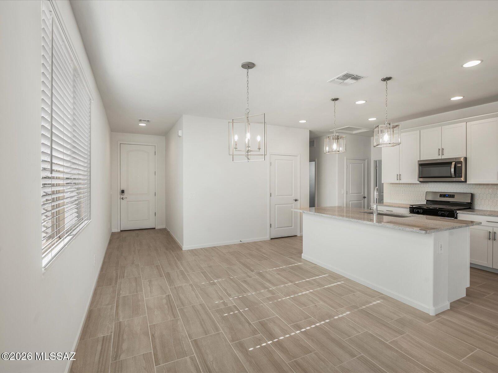 Move-in ready and designed for easy living! This charming single-story home offers 3 bedrooms, 2 bathrooms, and a 2-car garage with an open-concept layout that's perfect for entertaining. Unwind in the private primary suite, thoughtfully tucked away for added peace and privacy. Located in the highly anticipated Mandarina community in Marana, AZ, residents will enjoy resort-style amenities including a swimming pool, pickleball courts, playgrounds, a dog park, and more. This home comes complete with a washer, dryer, refrigerator, and whole-home blinds. Built with innovative, energy-efficient features, you'll enjoy enhanced comfort, healthier living, and potential savings for years to come.