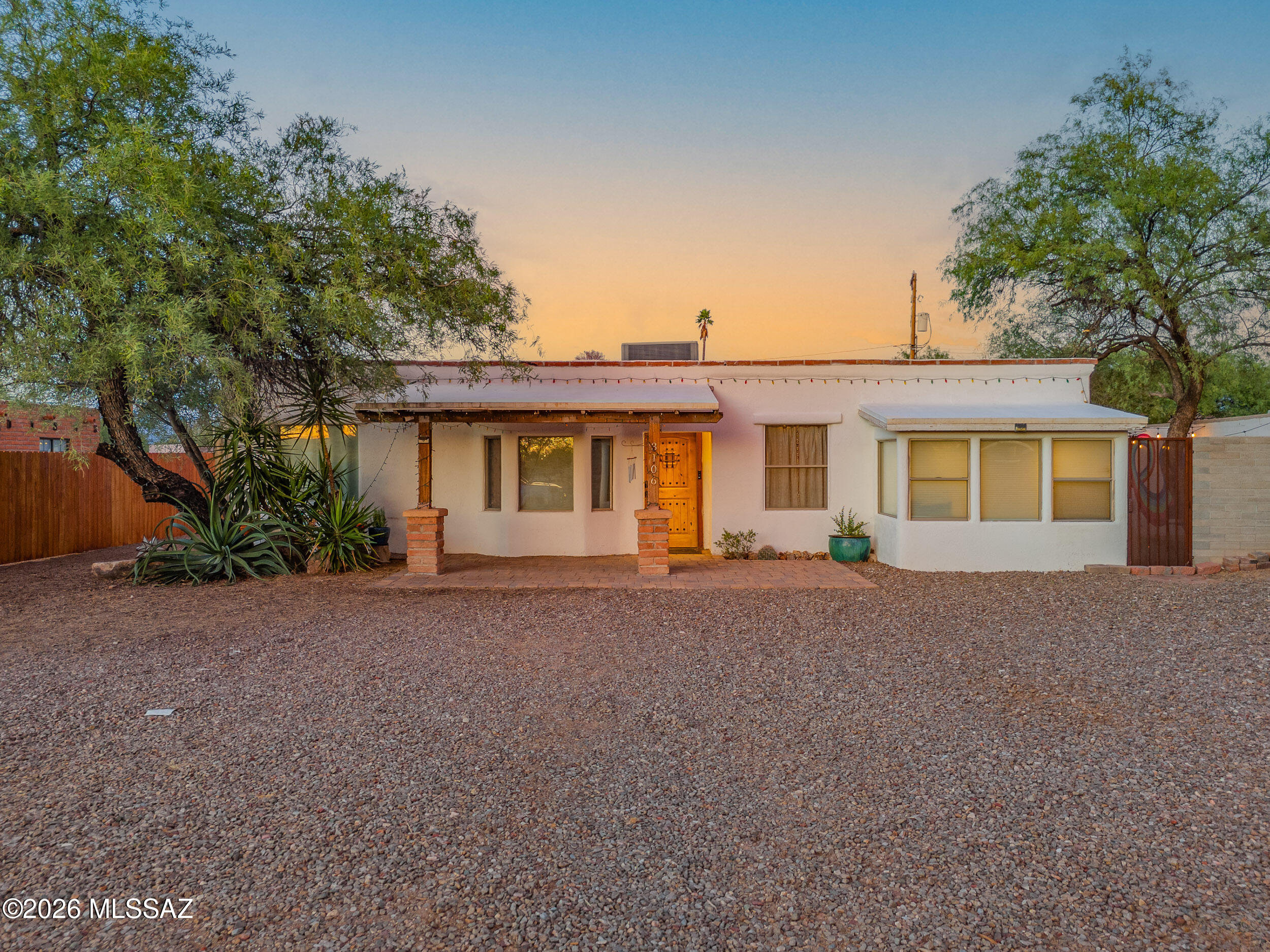 3108 N Tyndall being sold as well MLS # 22612213. Charming Central Tucson retreat featuring 3 bedrooms, 2 bathrooms, and a beautifully updated interior filled with character and style. The remodeled kitchen showcases sleek cabinetry, stainless steel appliances, skylights, open shelving, and generous counter space that flows into spacious living and dining areas with warm wood accents and modern finishes throughout. Situated on an oversized lot, the huge backyard is ideal for entertaining with string lights, colorful mural walls, mature trees, fire pit area, and endless room to relax or play. Detached garage offers flexible storage, workshop, or studio potential. Conveniently located near dining, shopping, parks, and the University area, this unique property blends Tucson charm with modern comfort and exceptional indoor-outdoor living.