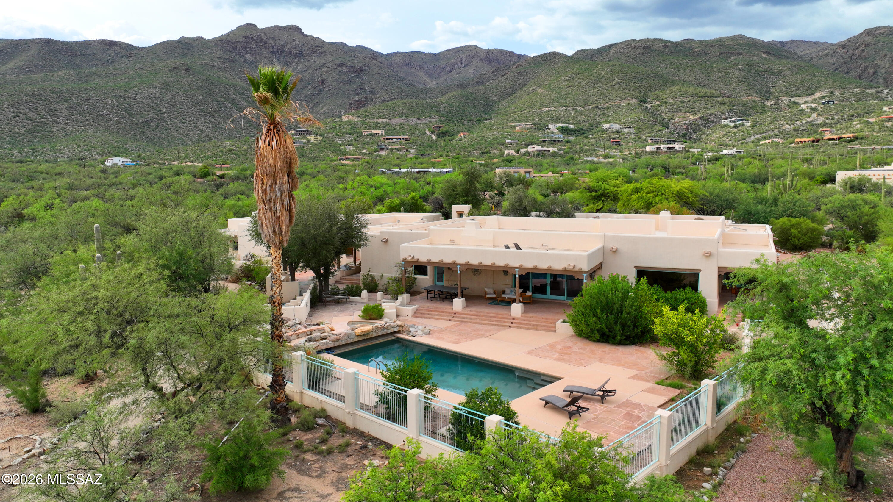 Don't miss this opportunity! Southwest luxury with this extraordinary Santa Fe-style estate nestled on 6.53 private acres at the base of the majestic Catalina Mountains in the heart of the Tanque Verde Valley. Designed with exceptional craftsmanship and timeless architectural detail, this one-of-a-kind horse property offers approximately 4800 square feet in the main residence with 4 bedrooms and 4.5 bathrooms, plus a beautifully appointed 1,800+ square-foot guest house featuring 2 bedrooms, 2 bathrooms, and a private sauna. From the moment you arrive, the home's striking architectural presence, artisan finishes, Copper ceilings, and top-quality materials set it apart. Flagstone flooring flows throughout the main home, while the gourmet kitchen features granite countertops, custom cabinetr and opens to a formal dining room designed for elegant entertaining. Expansive picture windows frame the breathtaking surroundings, filling the home with natural light. A stunning central courtyard, covered patios, sparkling pool, and roof top patio make for the perfect indoor-outdoor lifestyle.
Equestrians will appreciate the exceptional facilities, including a custom Santa Fe-style 5-stall barn with tack room and hay storage, fenced arena, round pen, private well, and acres of usable land. Ride directly from your property with immediate access to the Agua Caliente Wash, Tanque Verde Wash, and miles of scenic trails extending east toward the Rincon Mountains--allowing endless horseback adventures without ever loading a trailer.
Surrounded by mature desert vegetation, towering saguaros, palm trees and panoramic mountain vistas, this remarkable estate offers unmatched privacy while remaining just minutes from Tucson's conveniences. A rare opportunity to own one of Southern Arizona's finest luxury equestrian properties, where authentic Santa Fe architecture, world-class horse amenities, and spectacular desert beauty come together in perfect harmony.