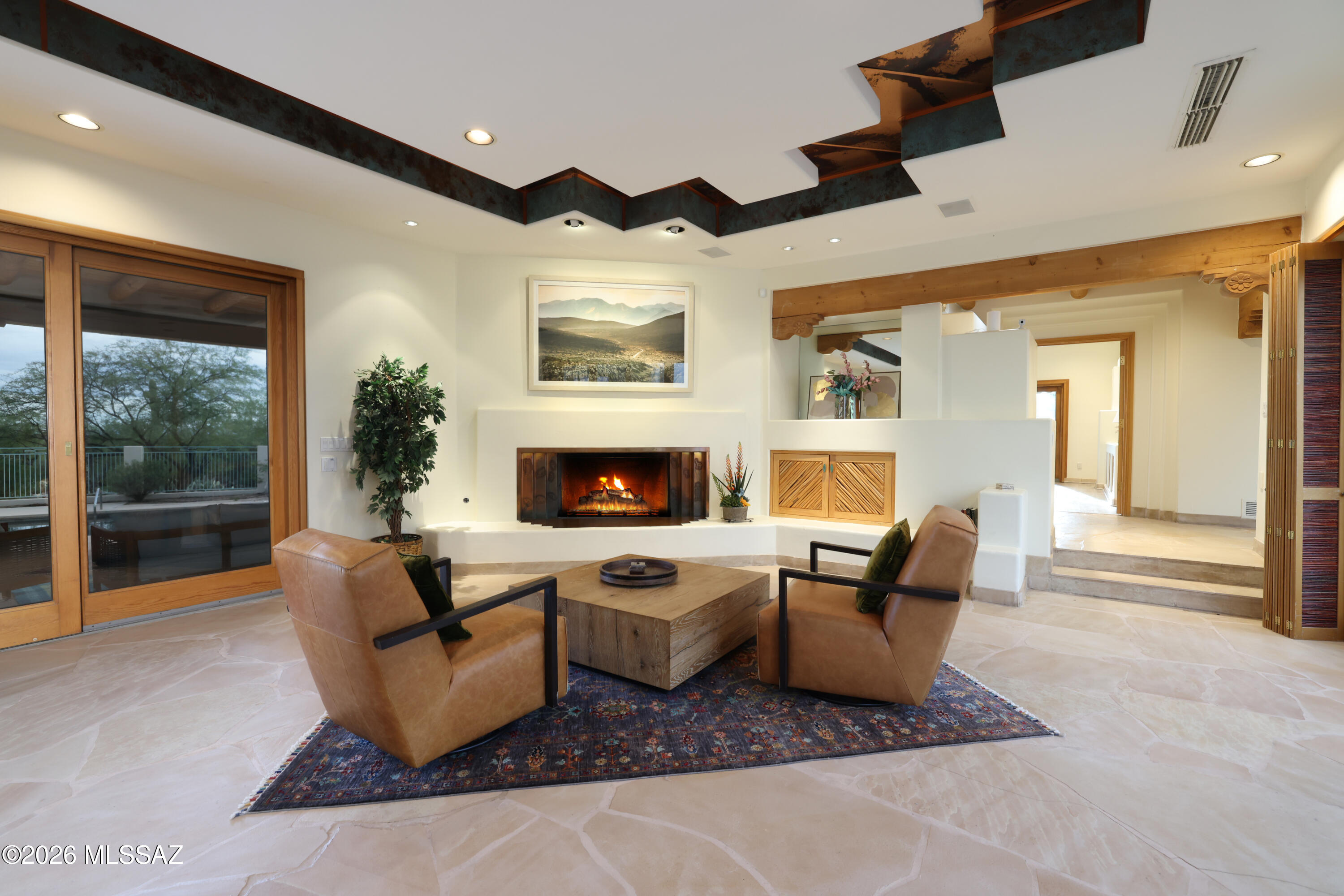 Don't miss this opportunity! Southwest luxury with this extraordinary Santa Fe-style estate nestled on 6.53 private acres at the base of the majestic Catalina Mountains in the heart of the Tanque Verde Valley. Designed with exceptional craftsmanship and timeless architectural detail, this one-of-a-kind horse property offers approximately 4800 square feet in the main residence with 4 bedrooms and 4.5 bathrooms, plus a beautifully appointed 1,800+ square-foot guest house featuring 2 bedrooms, 2 bathrooms, and a private sauna. From the moment you arrive, the home's striking architectural presence, artisan finishes, Copper ceilings, and top-quality materials set it apart. Flagstone flooring flows throughout the main home, while the gourmet kitchen features granite countertops, custom cabinetr and opens to a formal dining room designed for elegant entertaining. Expansive picture windows frame the breathtaking surroundings, filling the home with natural light. A stunning central courtyard, covered patios, sparkling pool, and roof top patio make for the perfect indoor-outdoor lifestyle.
Equestrians will appreciate the exceptional facilities, including a custom Santa Fe-style 5-stall barn with tack room and hay storage, fenced arena, round pen, private well, and acres of usable land. Ride directly from your property with immediate access to the Agua Caliente Wash, Tanque Verde Wash, and miles of scenic trails extending east toward the Rincon Mountains--allowing endless horseback adventures without ever loading a trailer.
Surrounded by mature desert vegetation, towering saguaros, palm trees and panoramic mountain vistas, this remarkable estate offers unmatched privacy while remaining just minutes from Tucson's conveniences. A rare opportunity to own one of Southern Arizona's finest luxury equestrian properties, where authentic Santa Fe architecture, world-class horse amenities, and spectacular desert beauty come together in perfect harmony.