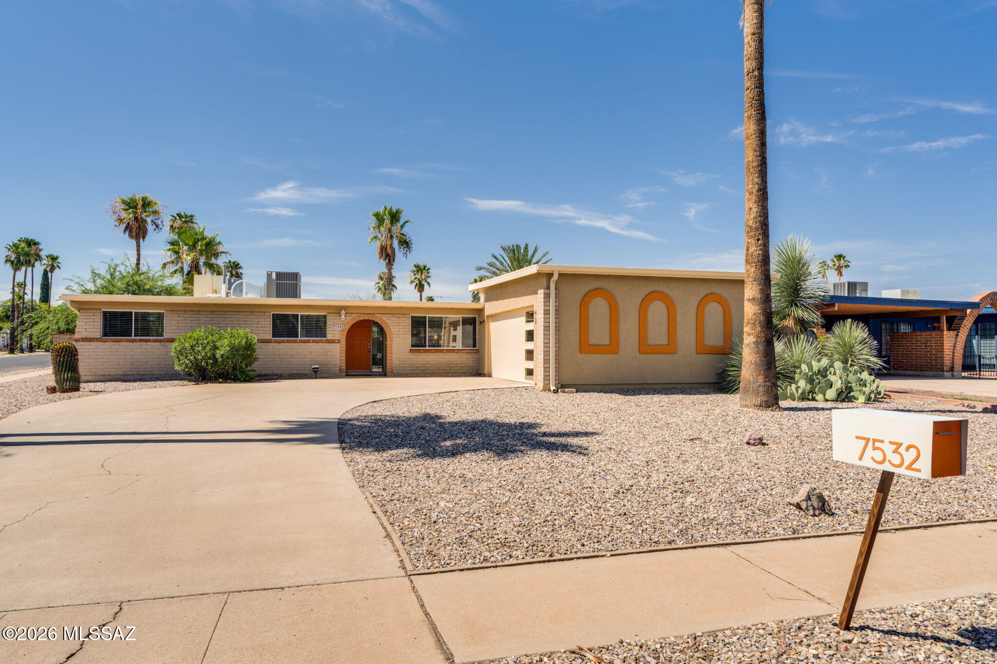 Solid block construction meets Pinterest-worthy style in this thoughtfully updated 1970s home! Tucked away on a quiet cul-de-sac near Udall Park, it offers the character and substance of an established home with a fresh, beautifully curated interior that feels anything but ordinary. The open-concept layout is filled with natural light, with plank flooring throughout and a living room featuring a stunning full wall of windows. The kitchen steals the show with white cabinetry, gold hardware, stainless steel appliances, a counter-to-ceiling backsplash, and a long bar topped with beautifully stained butcher block, open shelving, and plenty of seating. A charming dinette with built-in bench seating and updated chandeliers add even more personality. French doors off the primary bedroom lead to the backyard, while the primary bath features a sleek glass-enclosed shower. Newer HVAC and stylish side-light garage door! Outside, the peaceful landscaped backyard is surrounded by a private block wall and features a citrus tree and oversized covered patio with plenty of room for dining, entertaining, or simply relaxing. Solid, cool, and full of thoughtful details, this is the kind of home that looks like it came straight from your Pinterest board...but feels even better in person!