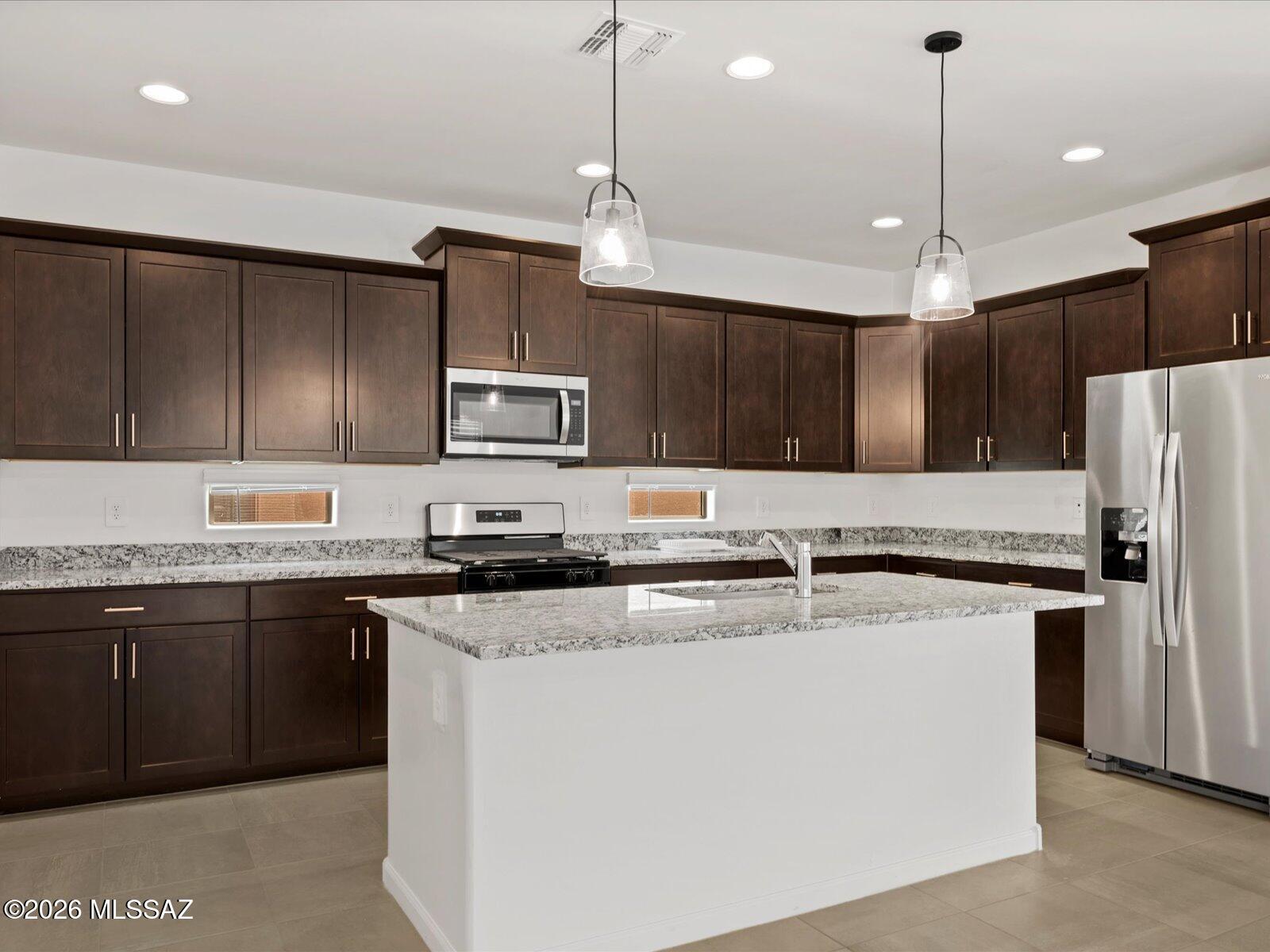 Energy Efficient. Vail School District. Appliances Included.

Discover the spacious Sunstone floorplan featuring 4 bedrooms and 3 baths with an open layout designed for modern living. The expansive kitchen with a large island flows effortlessly into the great room, perfect for entertaining. A flexible fourth bedroom near the main living area doubles as a home office, media room, or hobby space, complete with a walk-in closet. Located in a thoughtfully planned community within the Vail School District, enjoy amenities like pickleball courts, playgrounds, and a splash pad. Move-in ready with washer, dryer, refrigerator, and whole-home blinds, plus energy-efficient features for comfort, savings, and healthier living.