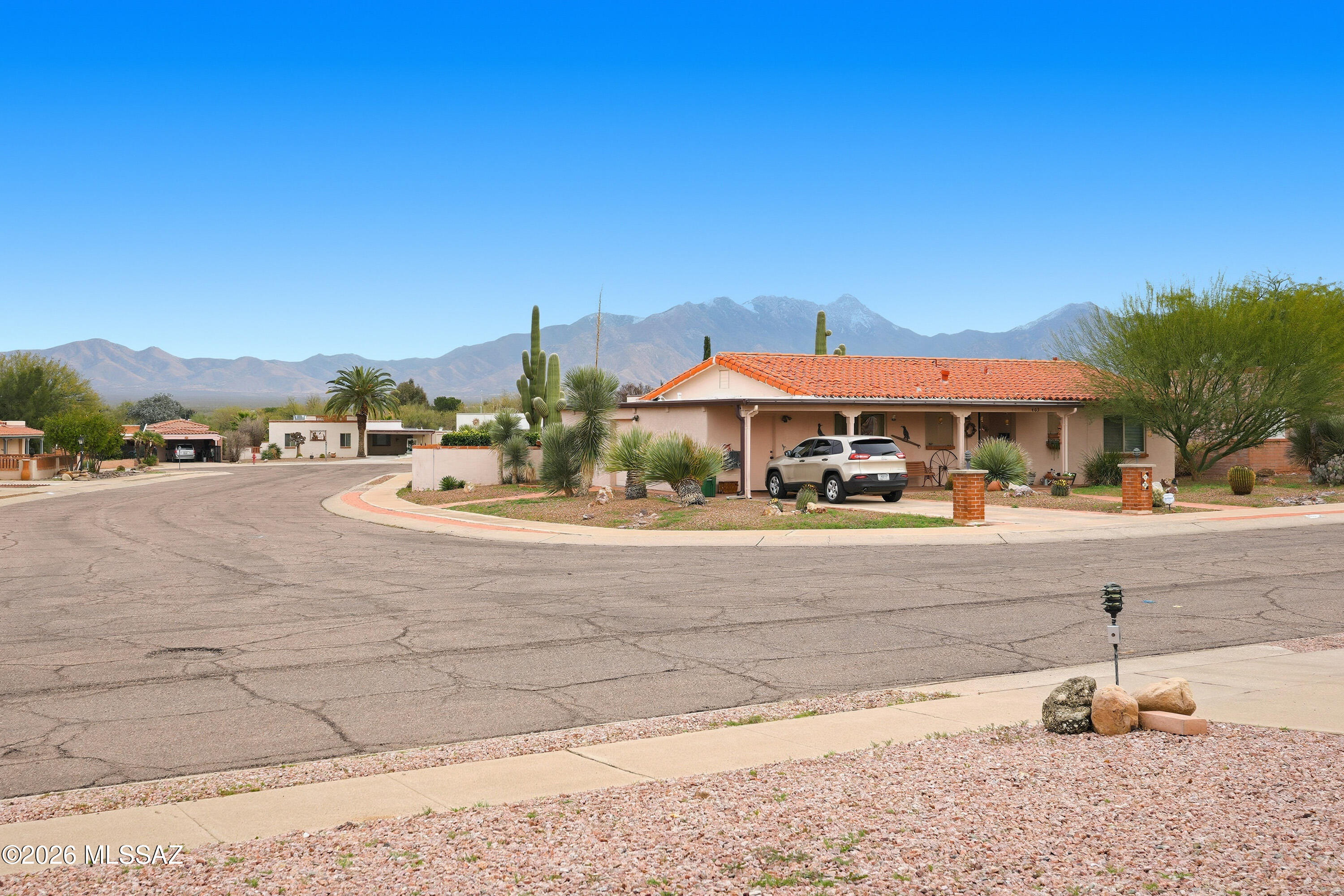 Come see this open, versatile home!
Enjoy mountain views sitting by an arched brick fireplace.  The low maintenance front provides enjoyment w/o requiring extensive care.  The back has brick patio with stone and plant accents; perfect for an evening sitting area.  The remaining backyard lot is open to your creativity.  this newly tiled two bed, two bath home, with two more flexible rooms that can convert into AZ rooms, home gym, or office spaces, offers a layout that flows.  The kitchen hosts plenty of cabinets and room to move, while providing a backyard view.  There is water softener in the home; with a walk-in shower in the primary bath a shower-tub combo in the other. Property SOLD AS IS.