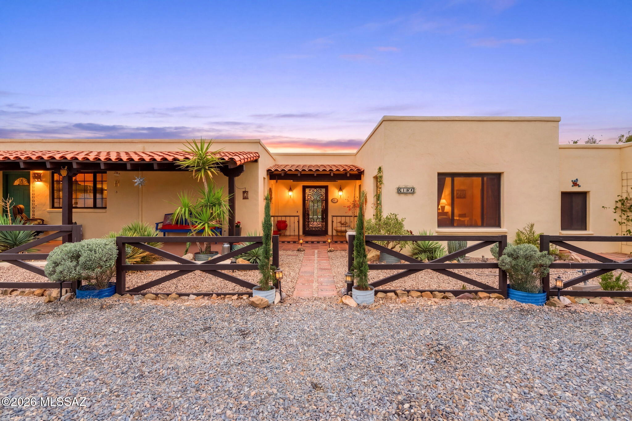 Nestled on over 4 acres of lush Sonoran Desert with stunning mountain views, this beautifully maintained hacienda-style estate offers the perfect blend of luxury and functionality for ranch or horse property living. Built with superior ICF construction, the home features a flexible 4-bedroom or 3-bedroom plus office layout, 3 full baths plus a powder room, including a private en-suite guest room. Custom upgrades throughout include Pella windows, solid wood doors, stained concrete floors, hand-painted tile, dual copper kitchen sinks, pot filler, gas cooktop, and stainless steel appliances. Outdoor amenities shine with a heated custom pool, private pickleball court, labyrinth outdoor kitchen/BBQ, covered patios, professional landscaping, exterior lighting, RV hookups with parking pad, & more