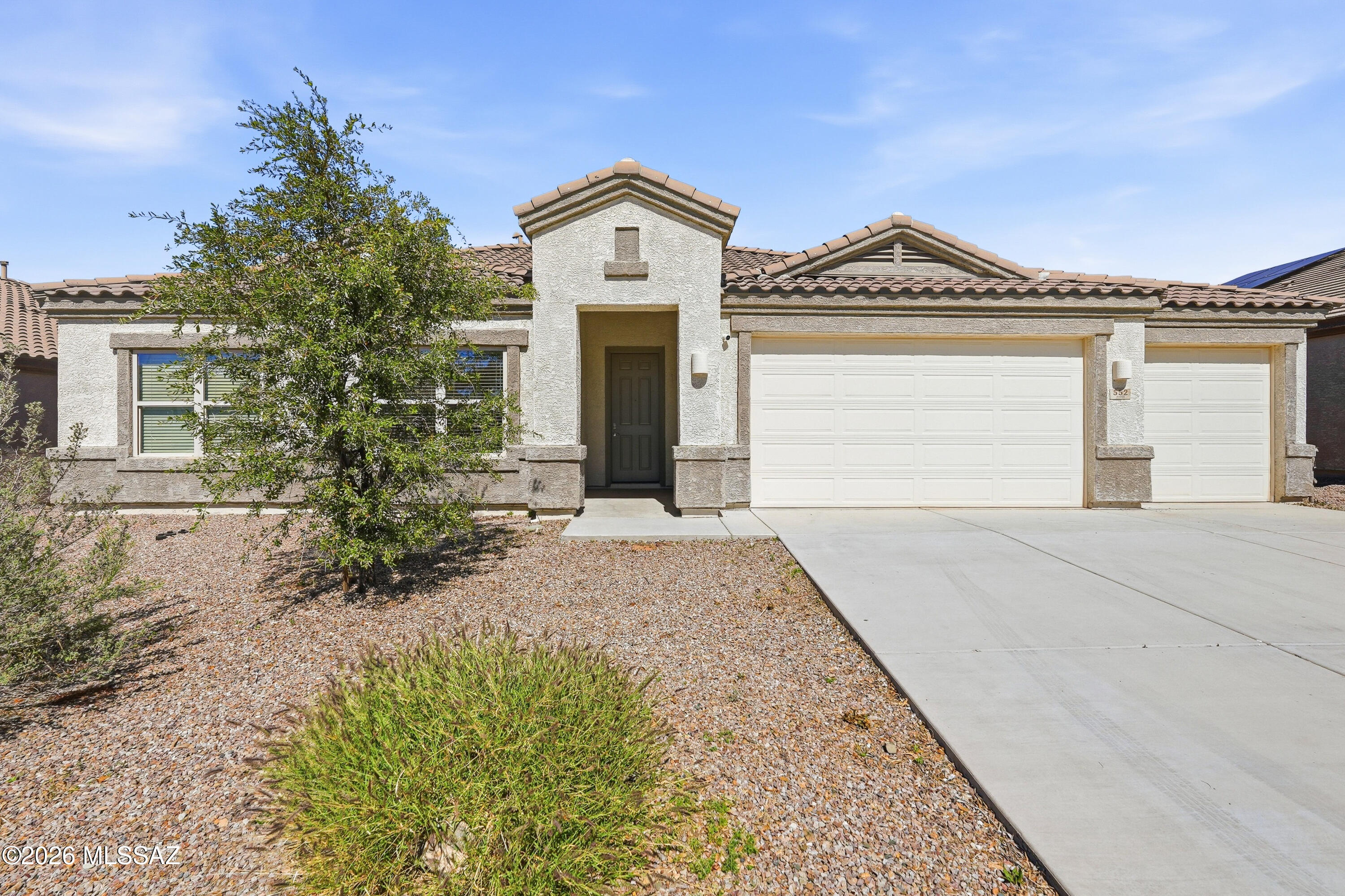 Welcome to modern desert living in the peaceful community of Corona de Tucson. This 2021 built, home blends contemporary comfort with the tranquility  of rural inspired living--offering space, privacy, and serenity. The open concept floor plan features 4 spacious bedrooms, 3 bathrooms, and a den. High ceilings, abundant natural light, and modern finishes elevate every room for a clean, refreshed feel. The kitchen offers a generous island, pantry, and seamless flow into the living/dining areas. Enjoy the low maintenance yard with room to entertain, garden, or unwind beneath the stars. This  home delivers the benefits of living away from the  hustle of the city while being minutes from top rated Vail schools, dining, & outdoor recreation. You will love the spacious 3 car garage with EV charg