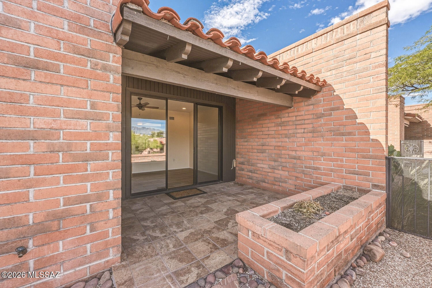 LOOKING FOR THE PERFECT WINTER RETREAT? Discover this fantastic desert casita featuring beautiful mountain views and a light, bright interior. Gorgeous wood-look ceramic tile flooring flows throughout the home, creating a warm and stylish feel. The beautifully remodeled kitchen offers granite countertops, a modern backsplash, updated soft close cabinetry, pantry cabinetry with pull-out shelves and stainless-steel refrigerator. The inviting great room features recessed lighting, a modern ceiling fan, and fresh interior paint. The updated bathroom includes an attractive walk-in tile shower. Step outside and enjoy peaceful mountain views from the lovely, private covered porch, perfect for morning coffee or relaxing Arizona evenings. Additional features include a convenient storage area with a stackable washer and dryer and covered parking directly in front of the unit. Ideally located near a Green Valley Recreation center, this charming casita is perfect as a winter getaway or comfortable year-round residence. Age-restricted 55+ community. Green Valley Recreation membership required. A must-see!