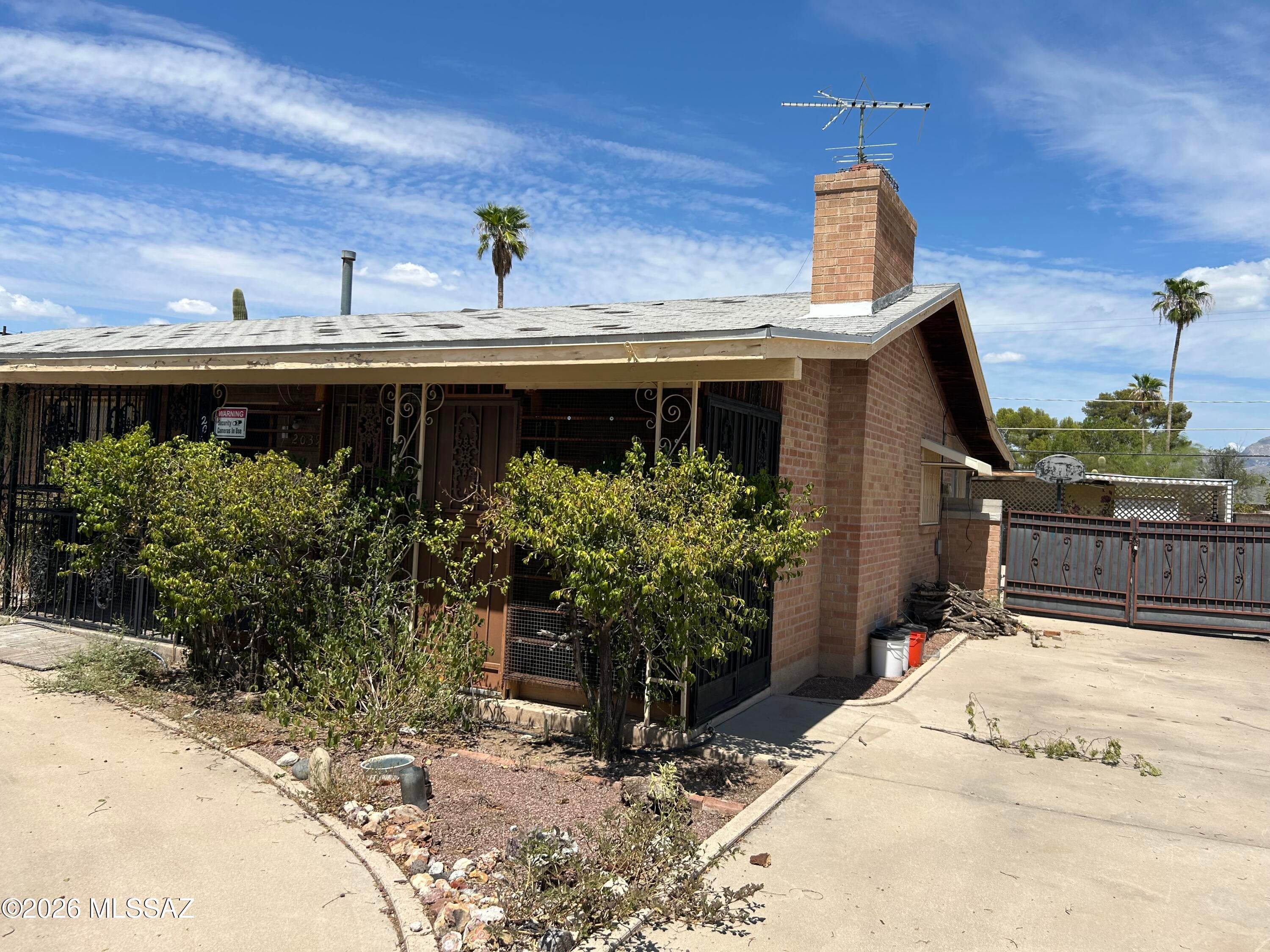 Exceptional investment and multi-generational living opportunity! This unique property offers two homes for the price of one with no HOA. The main home features 3 bedrooms, 2 baths, a cozy fireplace, bonus Arizona room off the kitchen, tile flooring throughout, scored concrete in the bedrooms, ceiling fans in every room, and a spacious kitchen with an island, tile backsplash, & included appliances. The recently remodeled guest house has its own private entrance, courtyard, backyard, laundry room, custom cabinetry, oversized tile shower, walk-in closet, large-format tile flooring, and fireplace. Live in one and rent the other, lease both for income, or enjoy the flexibility for extended family