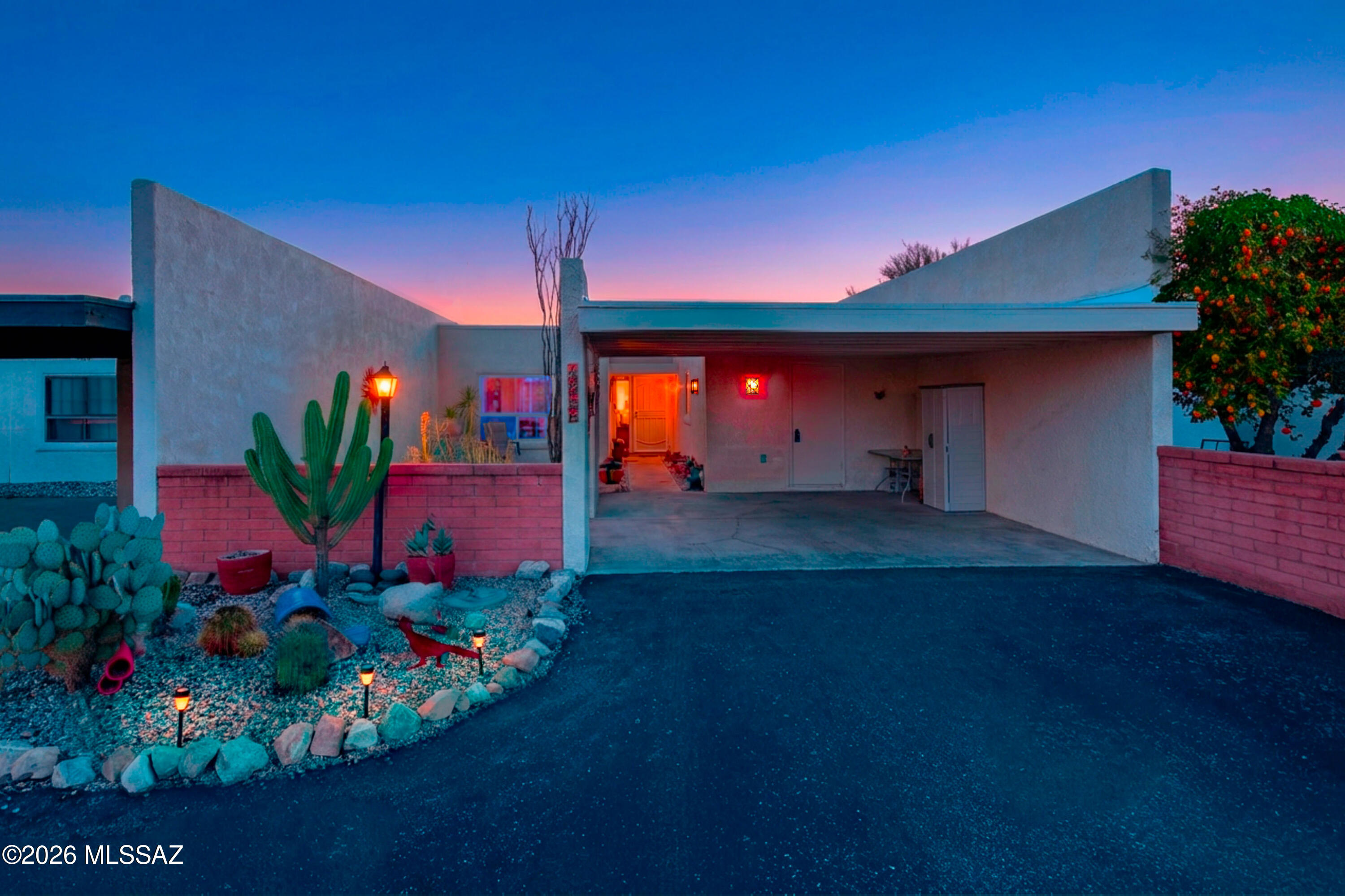 Pride of ownership shines in this immaculate 2-bedroom, 2-bath home with 2-car carport, move-in ready with fresh paint and tile and pergo flooring throughout—no carpet! The backyard is the true showstopper: positioned against vast open space with no rear neighbors, enjoy unobstructed mountain views from expertly landscaped desert gardens—perfect for morning coffee in your private, tranquil sanctuary. The Villages of Green Valley offers far more than a pool—it's a vibrant community hub with pickleball, shuffleboard, yoga, tai chi, art classes, pottery studio with wheel and kiln, plus monthly potlucks, all volunteer-run and included in your modest HOA fee. Step out your back door onto desert trails leading to the rec center in 15 minutes, perfect for active lifestyles.