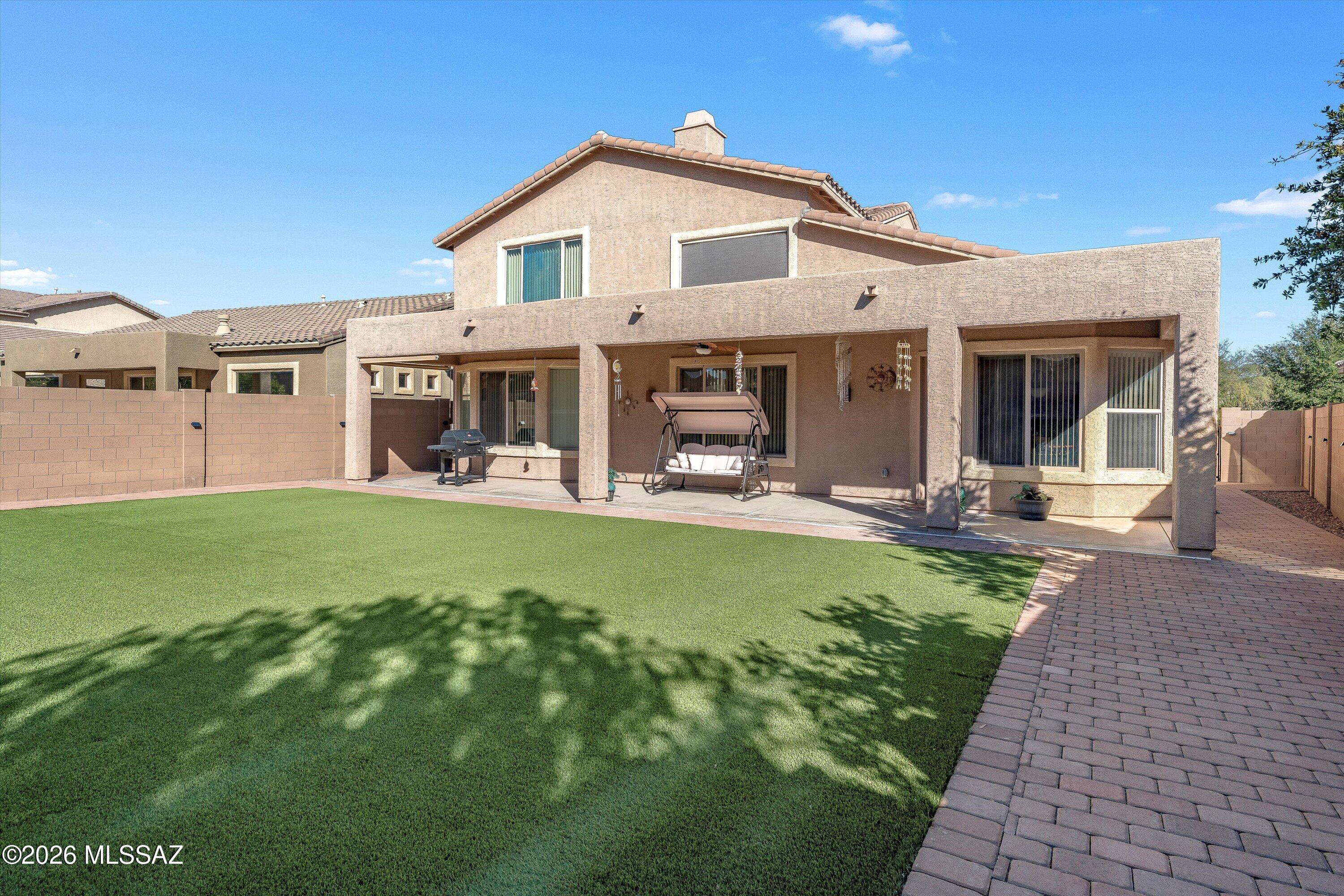 Set in one of Marana's most established communities, this impeccably maintained 4-bedroom, 3-bath home offers the space and flexibility today's buyers seek. With a main-floor primary suite, versatile office/den, formal dining, separate living and family rooms, and a versatile upstairs loft, this floor plan balances elegant entertaining spaces with comfortable everyday living.
Enter through a welcoming foyer where tile flooring sweeps through the main living areas. The expansive family room features soaring two-story ceilings, abundant natural light, and a gas fireplace with the loft overlooking from above. A separate living room at the front of the home provides additional space for formal entertaining or a quieter retreat. The open layout connects these spaces seamlessly while maintaining distinct areas for different needs.
Built for entertaining. The family room, kitchen, breakfast nook, and formal dining area flow together naturally. Conversation moves effortlessly from space to space while maintaining distinct zones. Whether hosting an intimate dinner or a larger gathering, the layout adapts. High ceilings and generous proportions create an airy, light-filled environment that feels both grand and welcoming.
A kitchen that works. Staggered-height maple cabinetry with crown molding, granite countertops, and a gas range anchor this well-appointed space. The oversized peninsula island with breakfast bar seating maintains clear sightlines to the family room. A walk-in pantry provides ample storage, while the breakfast nook offers casual dining with direct patio access. The separate dining room delivers elegant space for formal occasions.
The main-floor primary suite. Generously proportioned with backyard views, the primary bedroom features an ensuite bath with dual vanities, soaking tub, and walk-in shower. The oversized walk-in closet offers exceptional storage.
Flexible main-floor spaces. The versatile office/den works as dedicated workspace, library, or home gym. A powder room serves guests. The laundry room features built-in cabinets and a utility sink.
Upstairs expands your options. A substantial loft overlooks the family room below, ideal for a media room, play area, or second family space. Three generously sized bedrooms and a full bathroom with dual vanities complete the upper level.
Outdoor living, perfected. The deep covered patio overlooks low-maintenance artificial turf, mature desert landscaping, and western mountain views toward Twin Peaks. Designed for Arizona's climate with minimal upkeep.
Ironwood Ridge at Continental Reserve offers convenient access to Marana's best amenities. Minutes to I-10, Cortaro and Silverbell Road corridors for shopping and dining, Twin Peaks hiking trails, and local golf courses. 
Schedule your private showing today and discover why this extraordinary property won't last long.