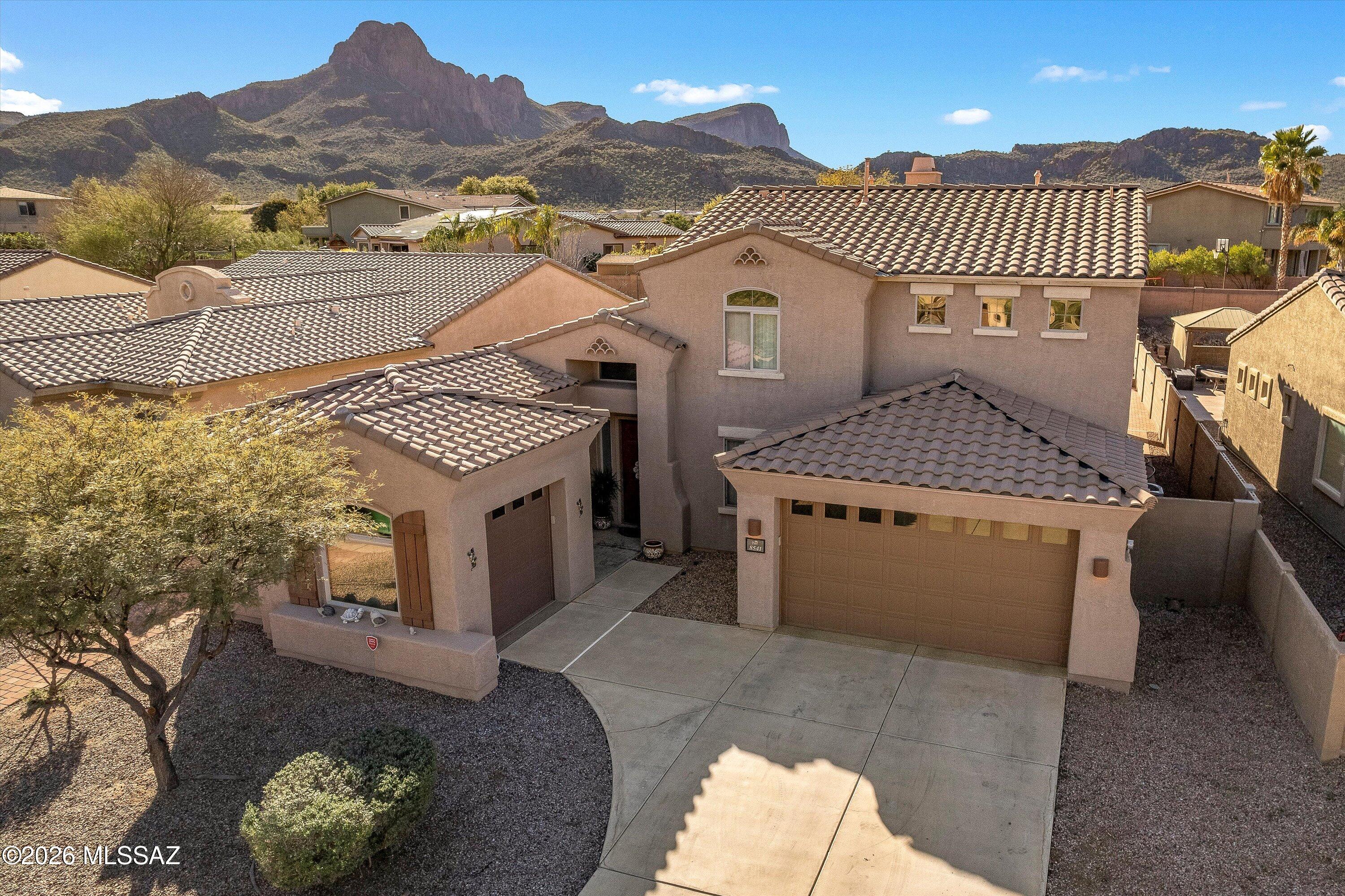 Move-in ready and spacious, this 3,125 sq ft, 4-bedroom, 3-bath home in Continental Reserve features a downstairs primary suite and an expansive great-room layout with an open kitchen, family room and breakfast nook. The flexible floor plan also includes a separate living room, formal dining room, office/den and a generous upstairs loft.
At the heart of the home, the kitchen opens directly to the dramatic two-story family room and breakfast nook, creating a bright and connected great-room setting. The kitchen features granite countertops, maple cabinetry with crown molding, a gas range, walk-in pantry and an oversized peninsula with bar seating. Just beyond, the family room offers soaring ceilings, abundant natural light and a gas fireplace, with the upstairs loft overlooking the space below.
The downstairs primary suite is privately positioned and features backyard views, a large walk-in closet and an ensuite bath with dual vanities, soaking tub and separate shower. Also on the main level are a dedicated office/den, separate living room, formal dining room, guest powder room and laundry room with built-in cabinetry and a utility sink.
Upstairs, a spacious loft provides another substantial living area, along with three additional bedrooms and a full bath with dual vanities.
Outside, a deep covered patio overlooks artificial turf, mature desert landscaping and western mountain views toward Twin Peaks, offering an inviting low-maintenance space to enjoy Arizona outdoor living.
Located in Ironwood Ridge at Continental Reserve with convenient access to I-10, shopping, dining, hiking and golf, this well-maintained home offers an impressive amount of living space and a floor plan that is ready for its next owner.