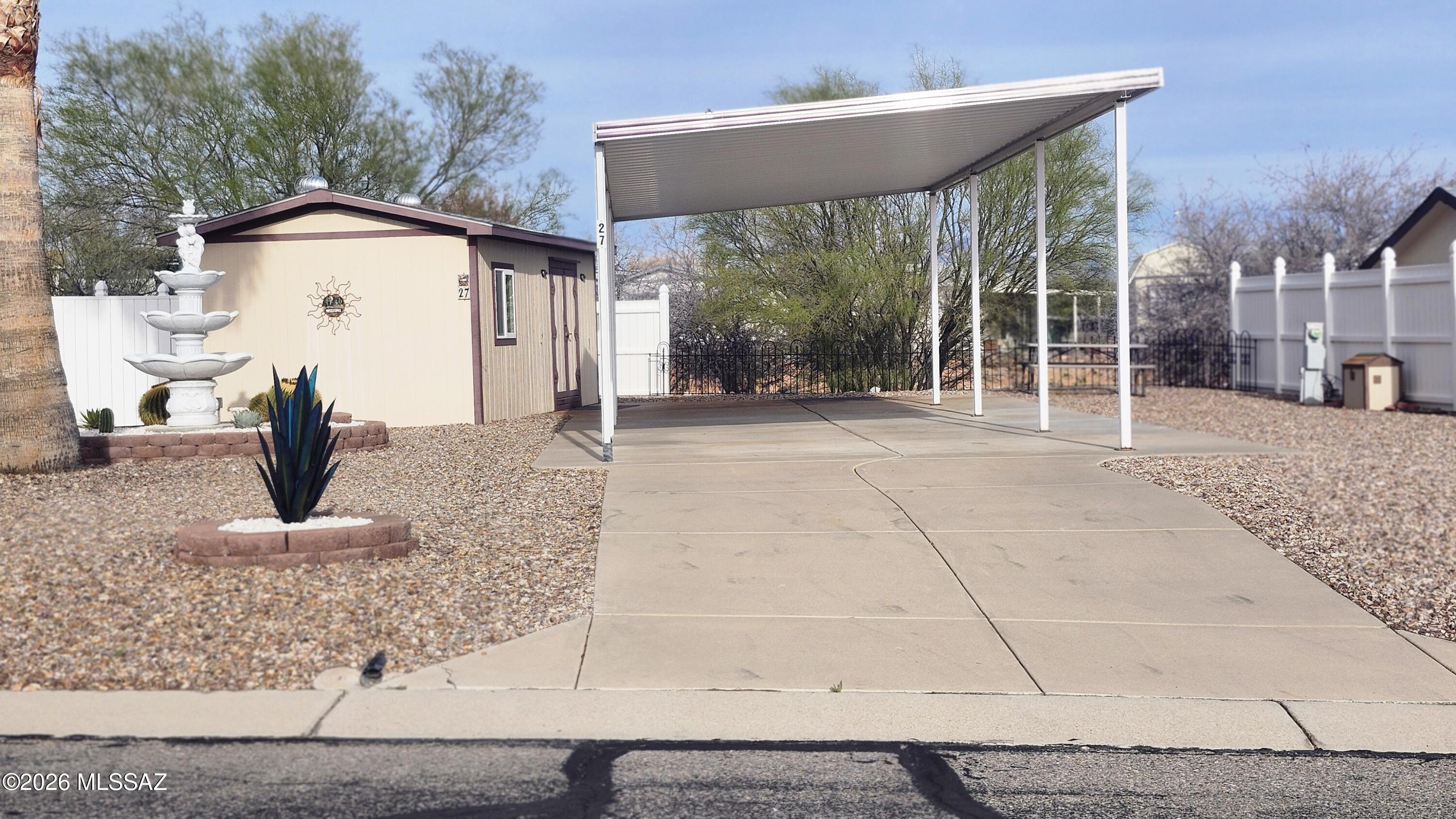 4700+ sq ft RV lot in the 55+ gated area at Cochise Terrace, Covered Patio/Driveway on a concrete pad. Storage shed on the lot provides plenty of extra storage for those ''once in awhile'' used items. Partially fenced in yard with your very own palm tree and fountain.