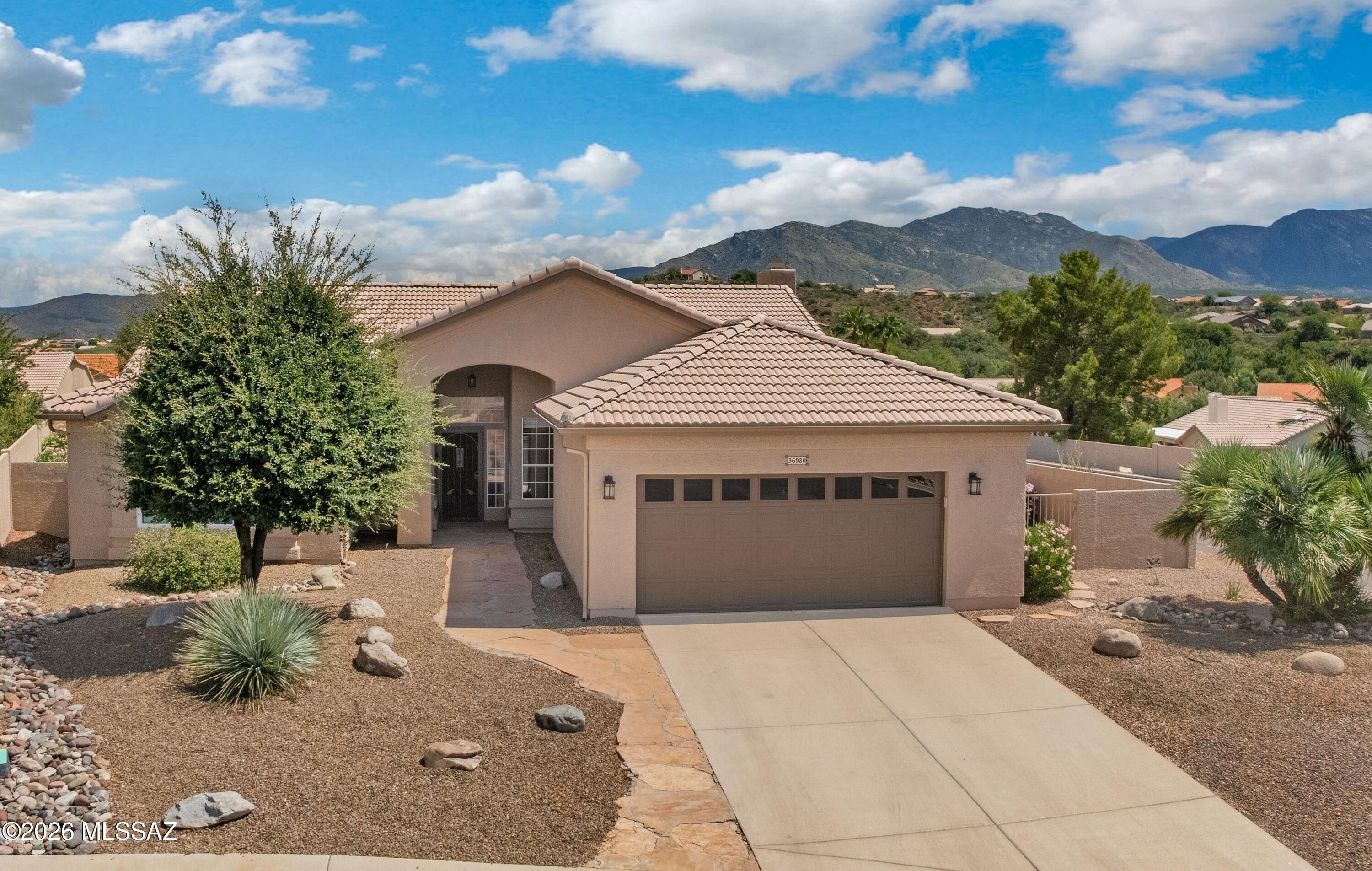 Nicely Updated Madera situated on Cul-de-Sac Lot with Heated Pool, Spa & Mountain Views! ''Roof Underlayment Replaced 2025''! Foyer opens to Great Room with patio slider. Kitchen has granite counters, stainless appliances, electric cooktop with vent, cabinets with slide-outs & garden window with Mountain Views. Breakfast Nook, Powder Room & Wet Bar Area. Family Room with Gas Fireplace & patio slider. Owner's Suite has patio slider & EnSuite Bath with dual vanities, granite counters, walk-in shower & walk-in closet. Den/Office with closet. Guest Bedroom with closet & Guest Bath nearby. Tile & Luxury Vinyl Plank flooring thru-out. Laundry Room with W/D & cabinets. 2-Car Garage with cabinets. Covered Patio with Heated Pool/Spa, Gated Yard, & Mountain Views-perfect for relaxing & entertaining!